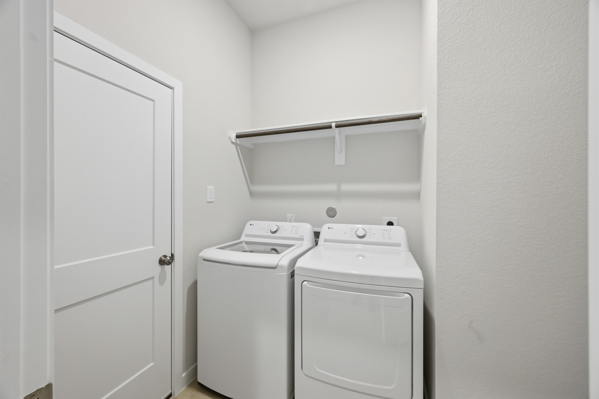 A washing machine and dryer in a room.