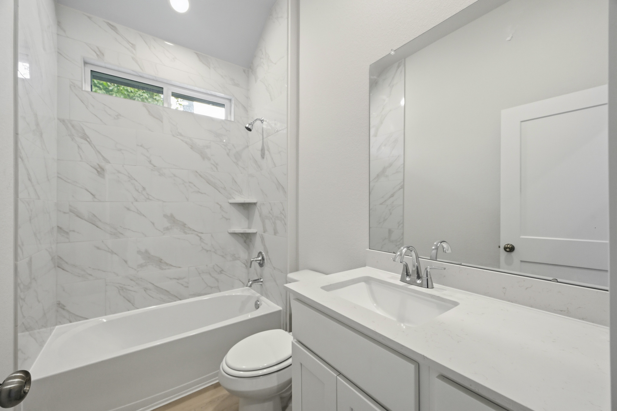A bathroom with a tub sink and toilet.