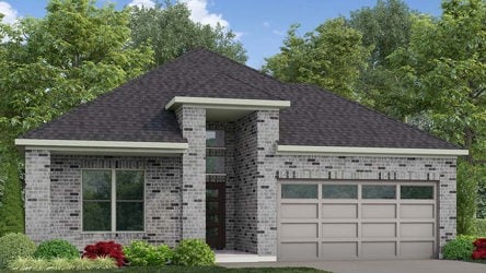 A house with a garage and trees in the back.
