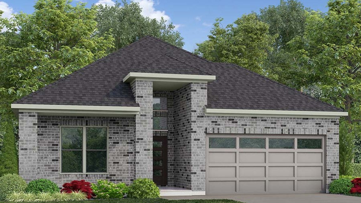 A house with a garage and trees in the back.