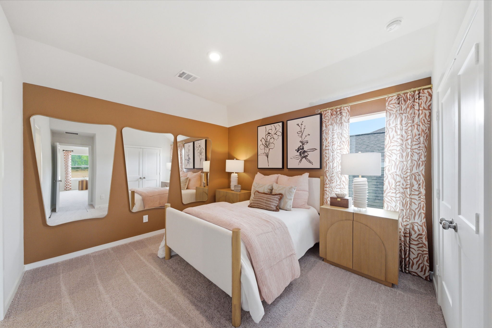 A bedroom with a bed and a mirror.