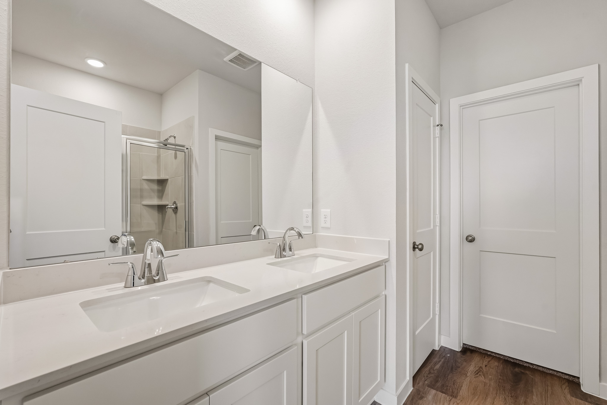 A bathroom with white cabinets.