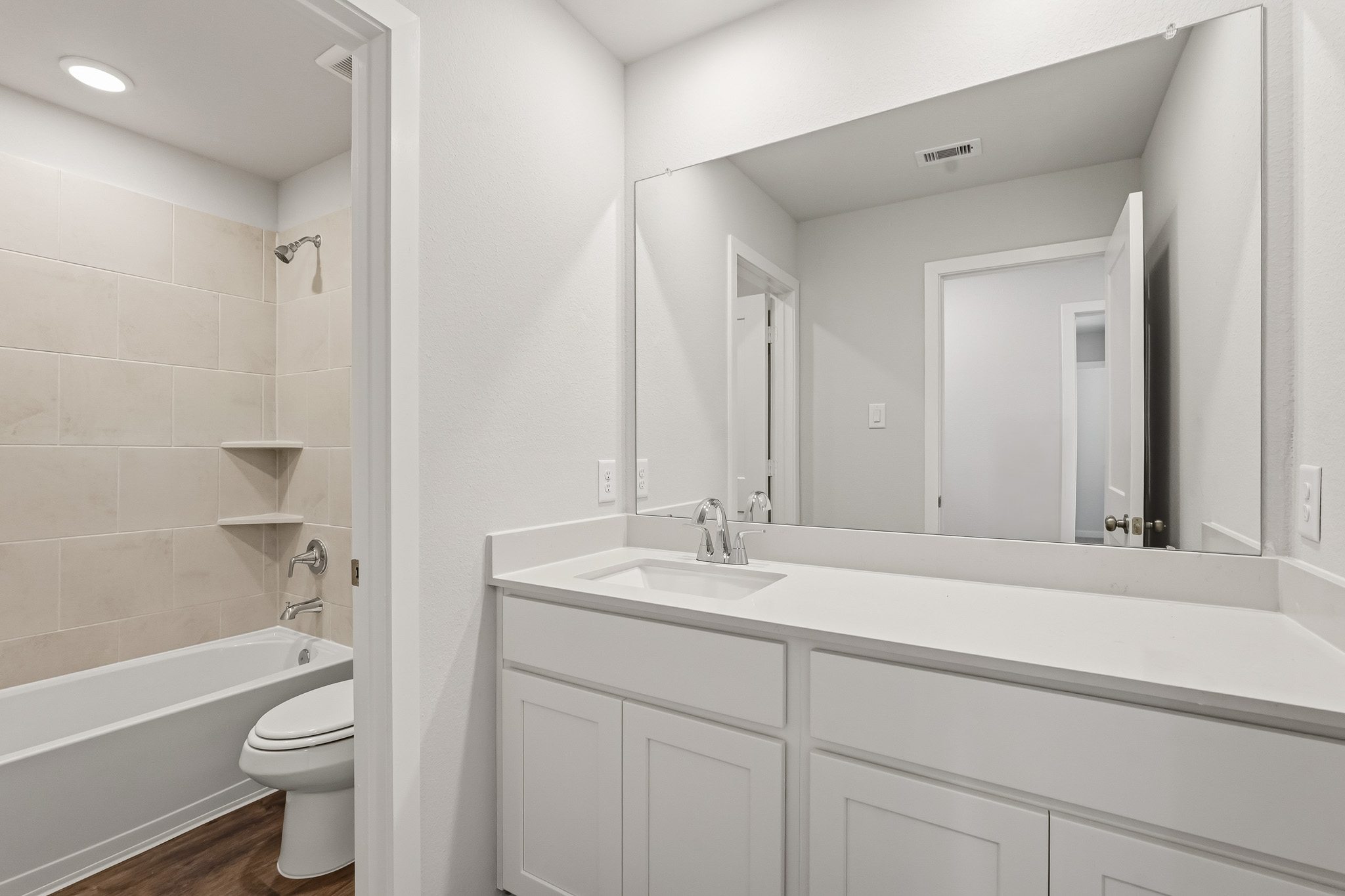 A bathroom with a tub sink and toilet.