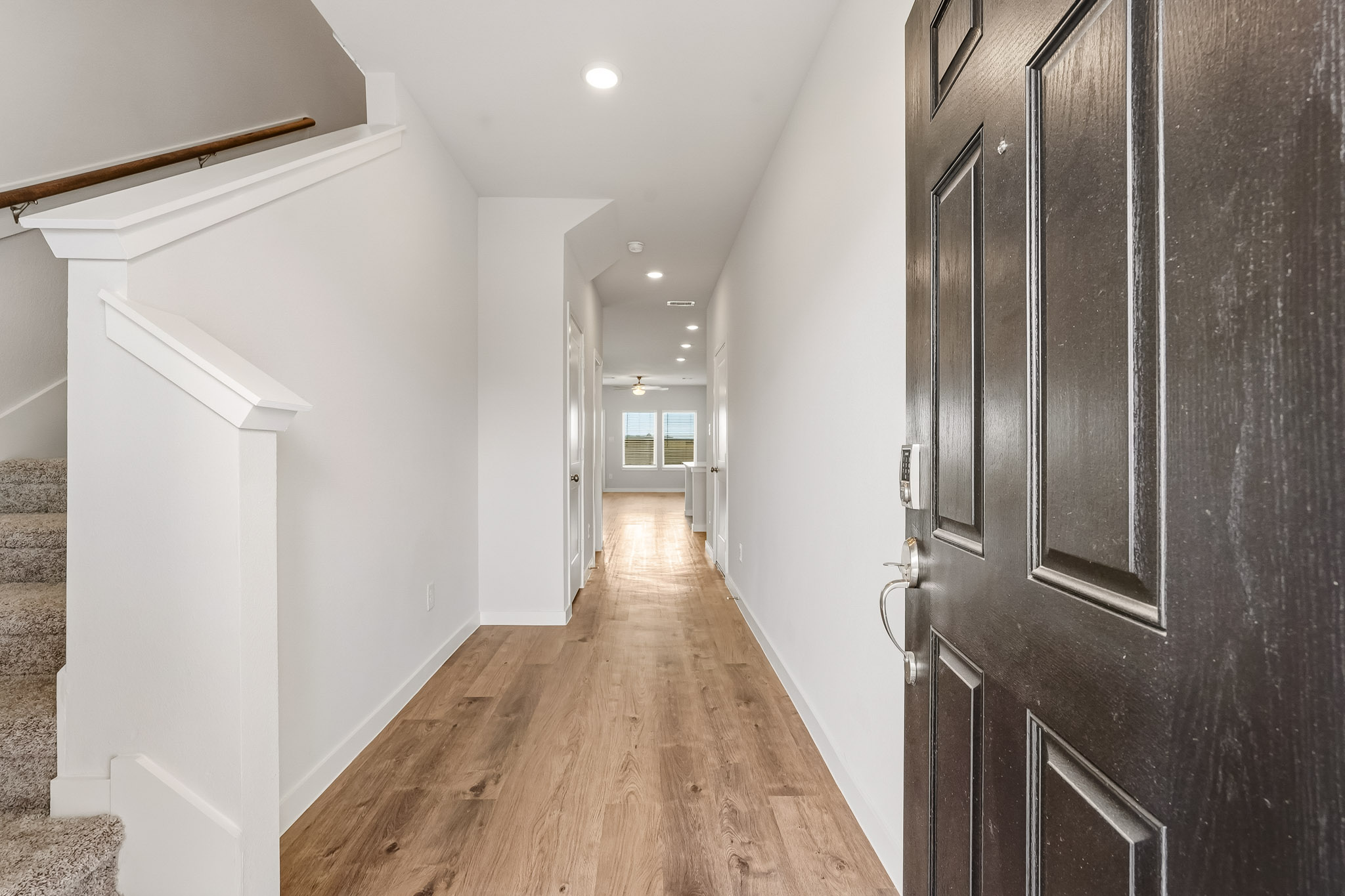 A hallway with black doors.