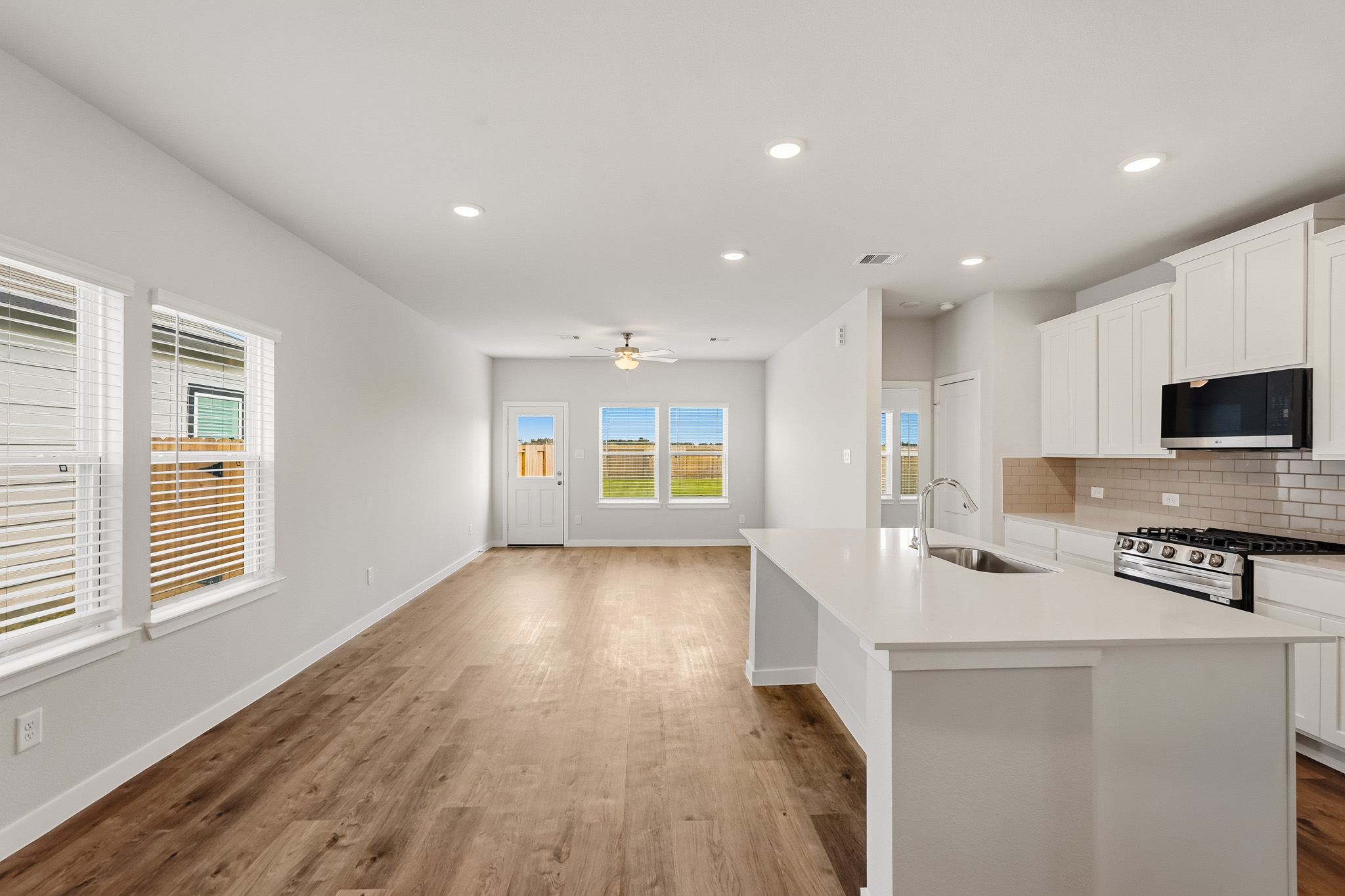A kitchen with white cabinets.
