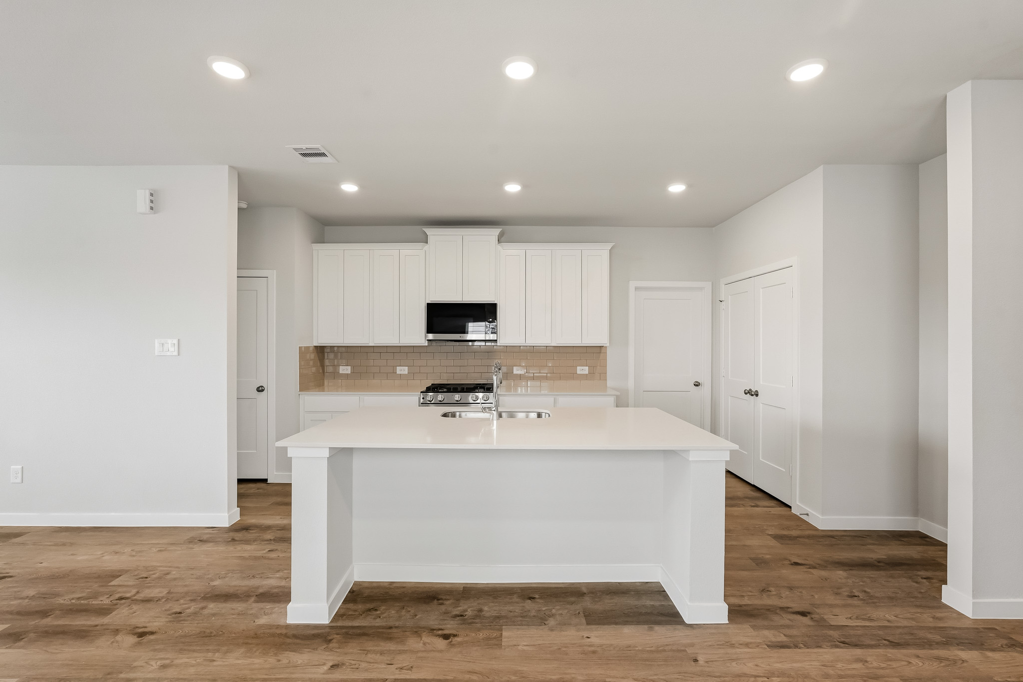 A large kitchen with white cabinets.
