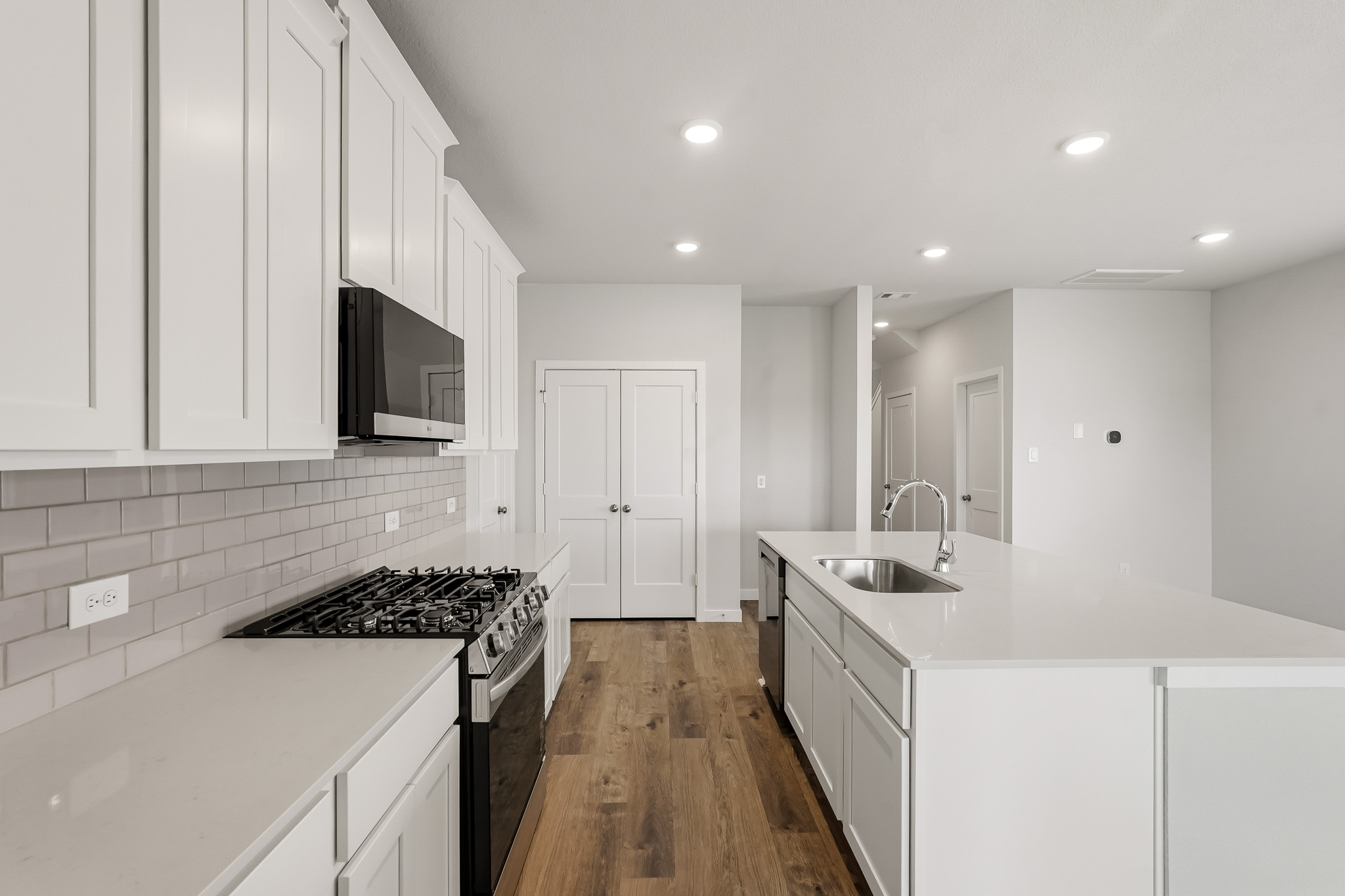 A kitchen with white cabinets.
