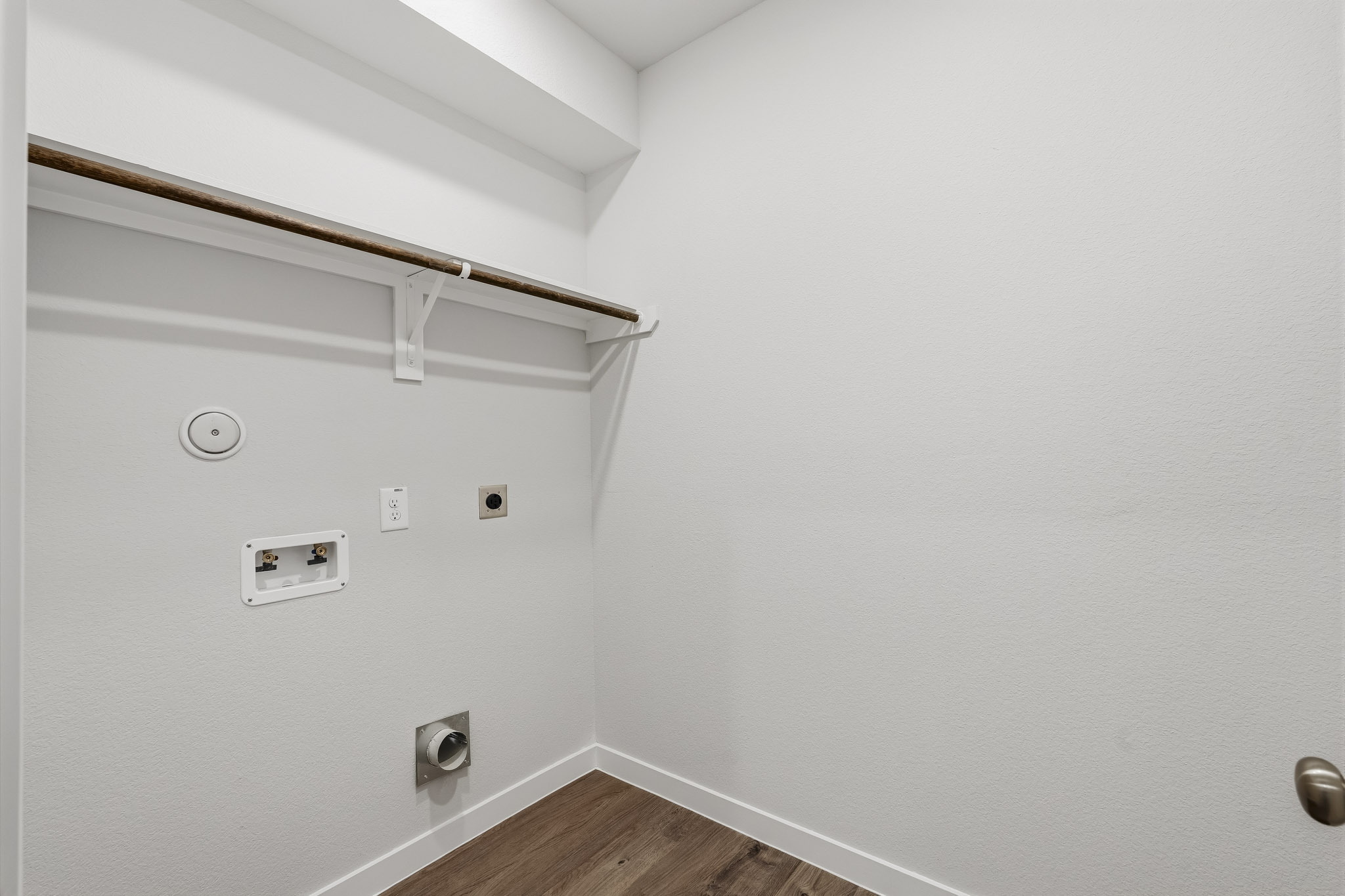 A white wall with a light fixture.