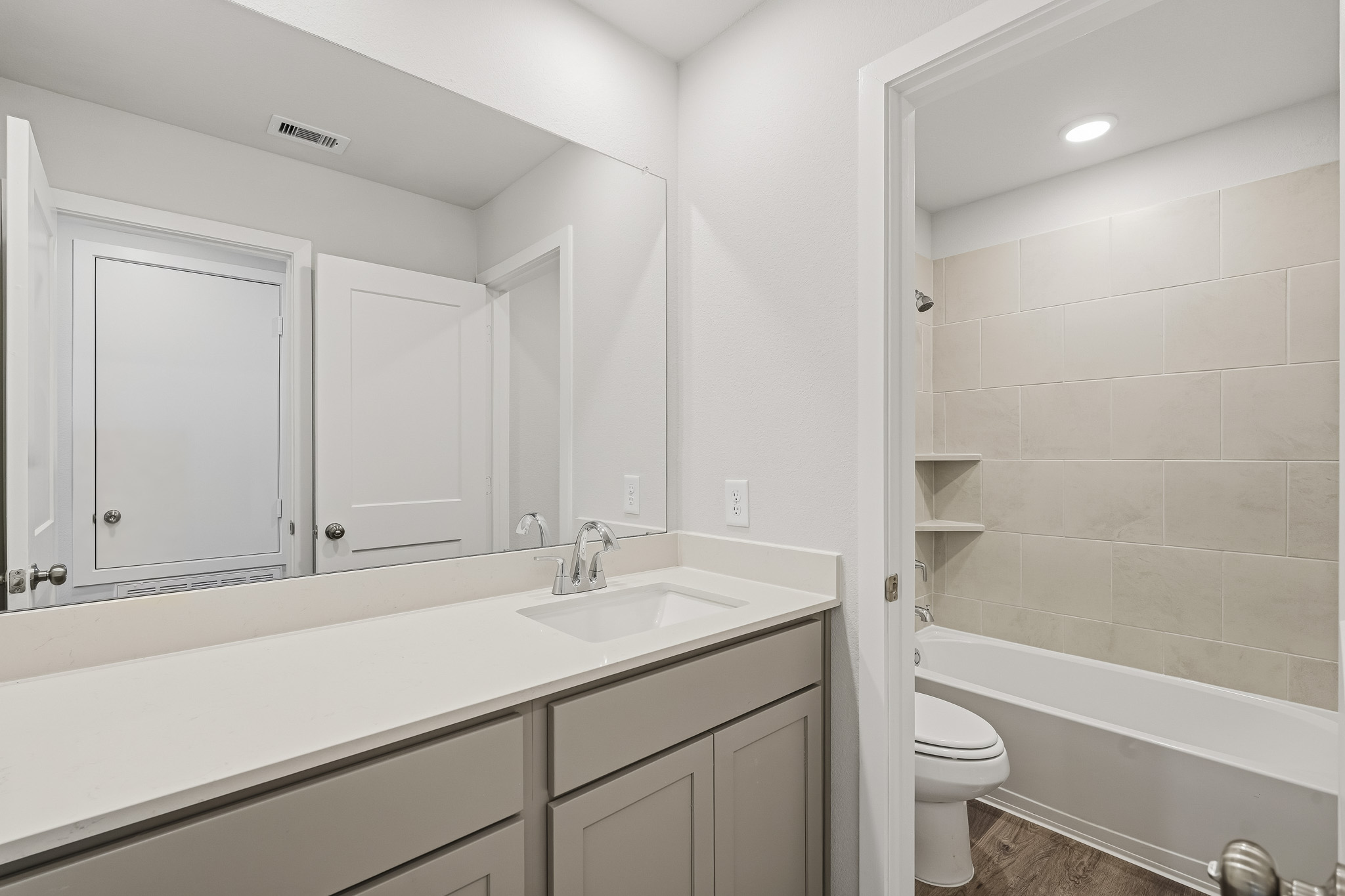 A bathroom with a tub sink and toilet.