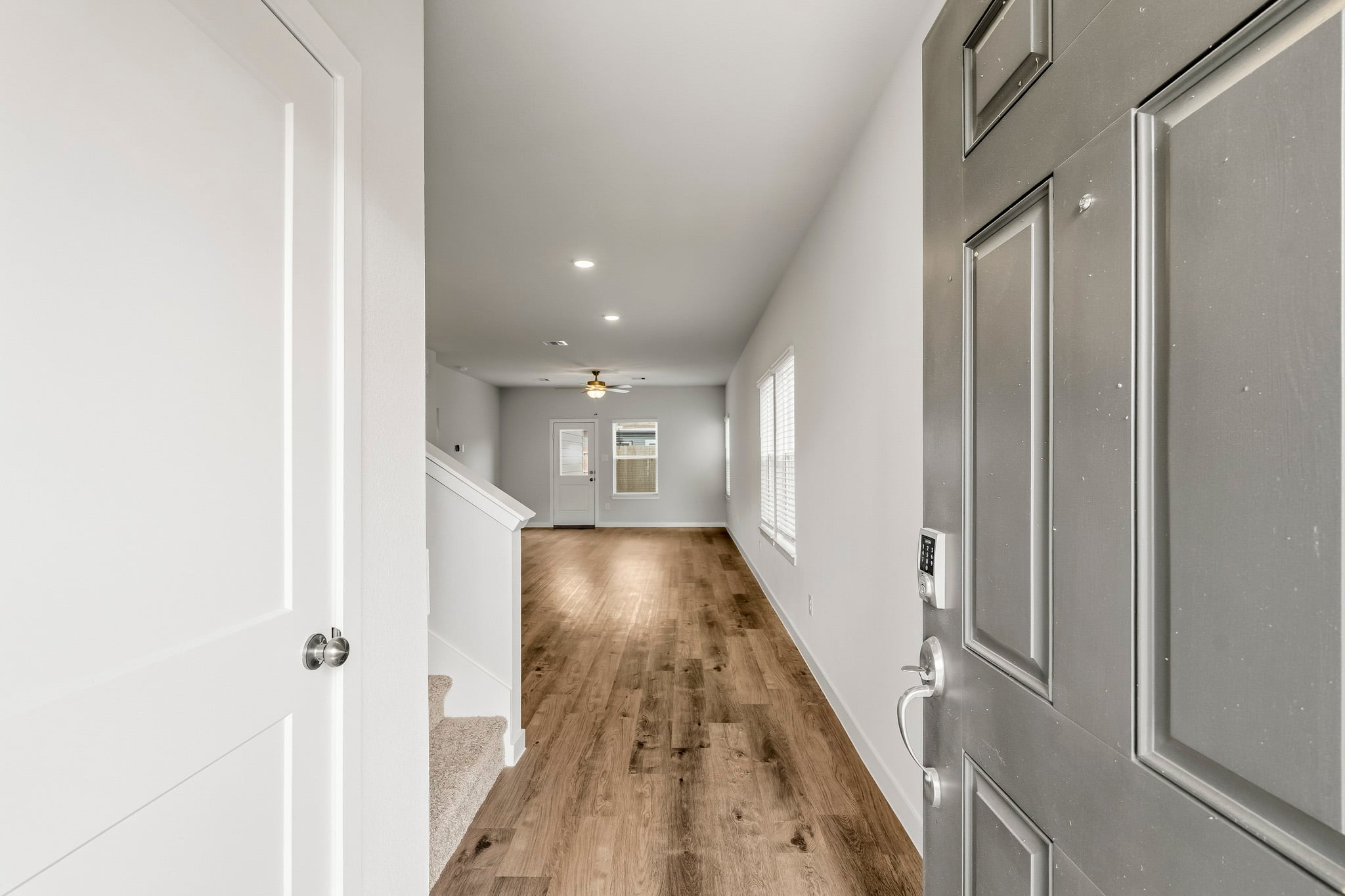 A hallway with white doors.