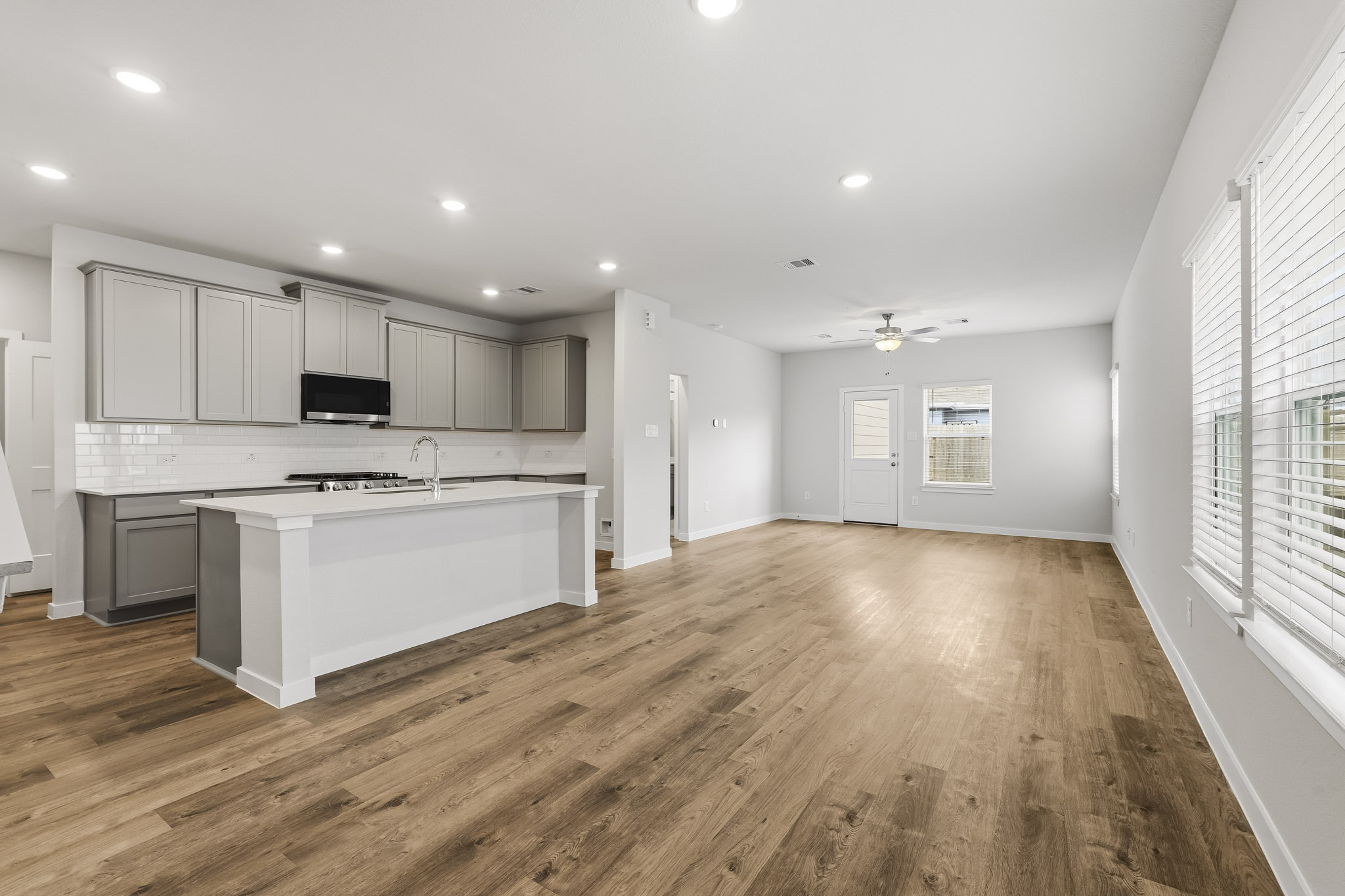 A kitchen with white cabinets.