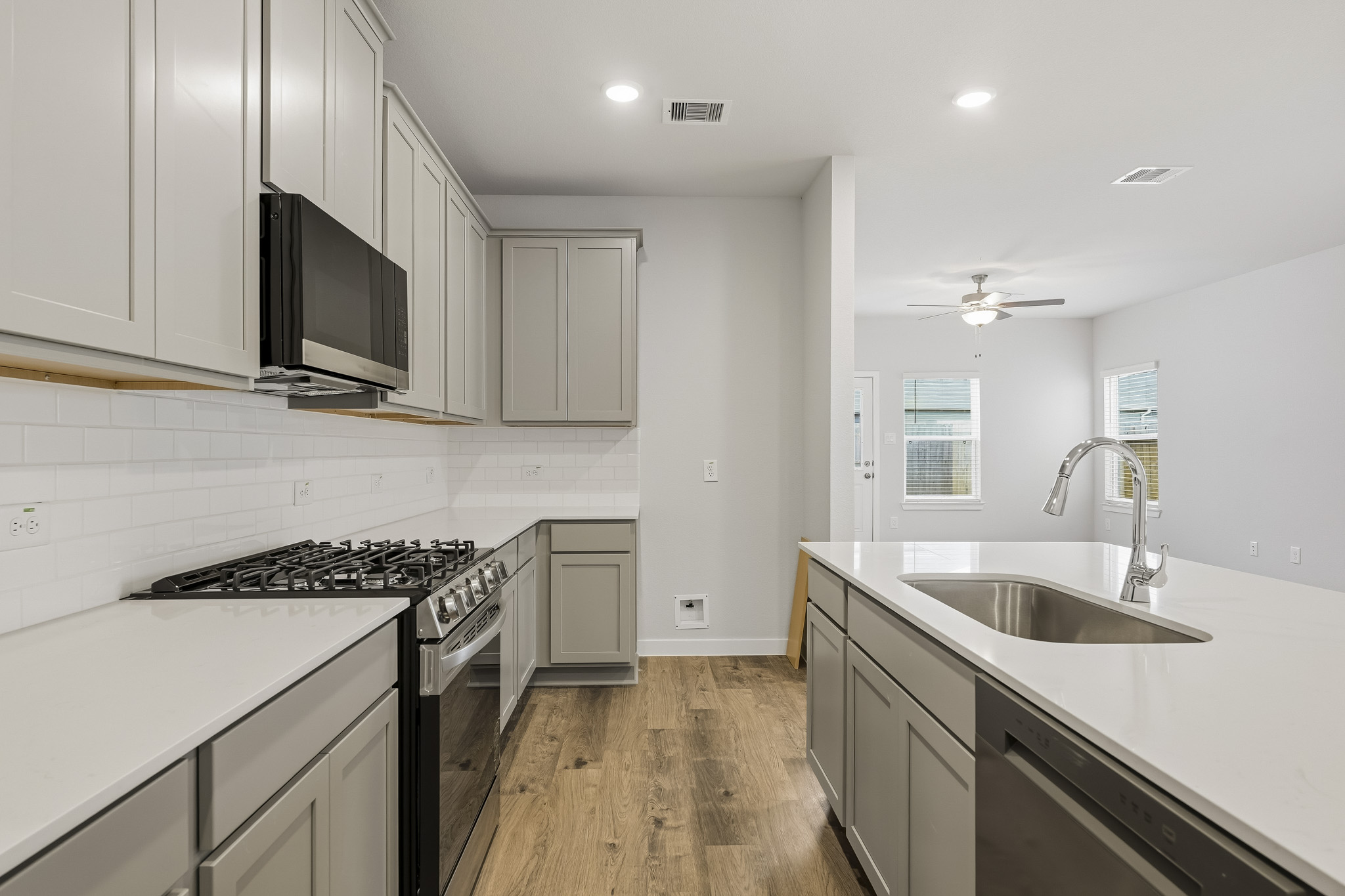 A kitchen with white cabinets.