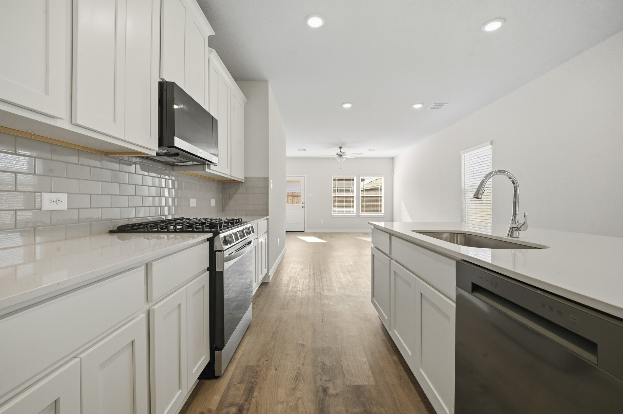 A kitchen with white cabinets.