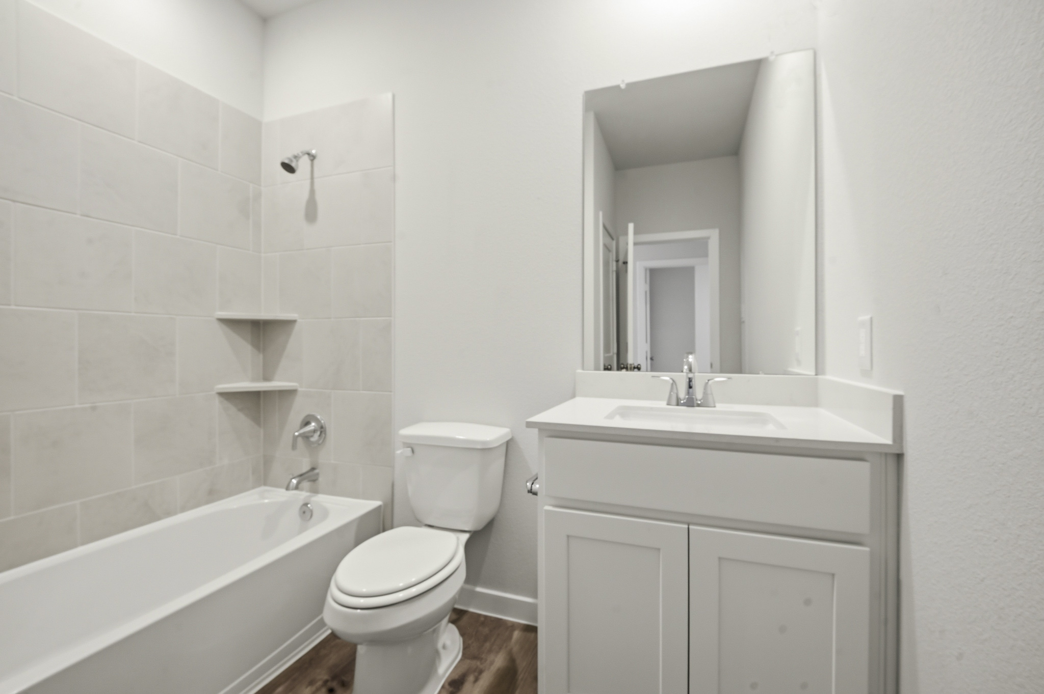 A bathroom with a tub sink and toilet.