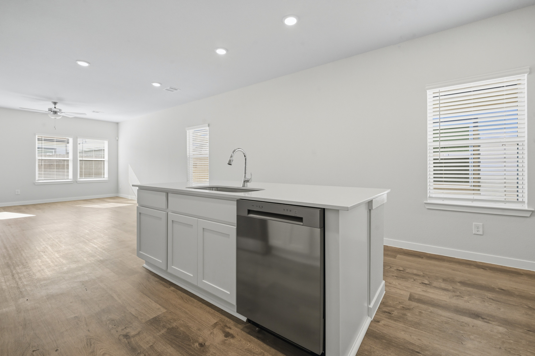 A kitchen with white cabinets.