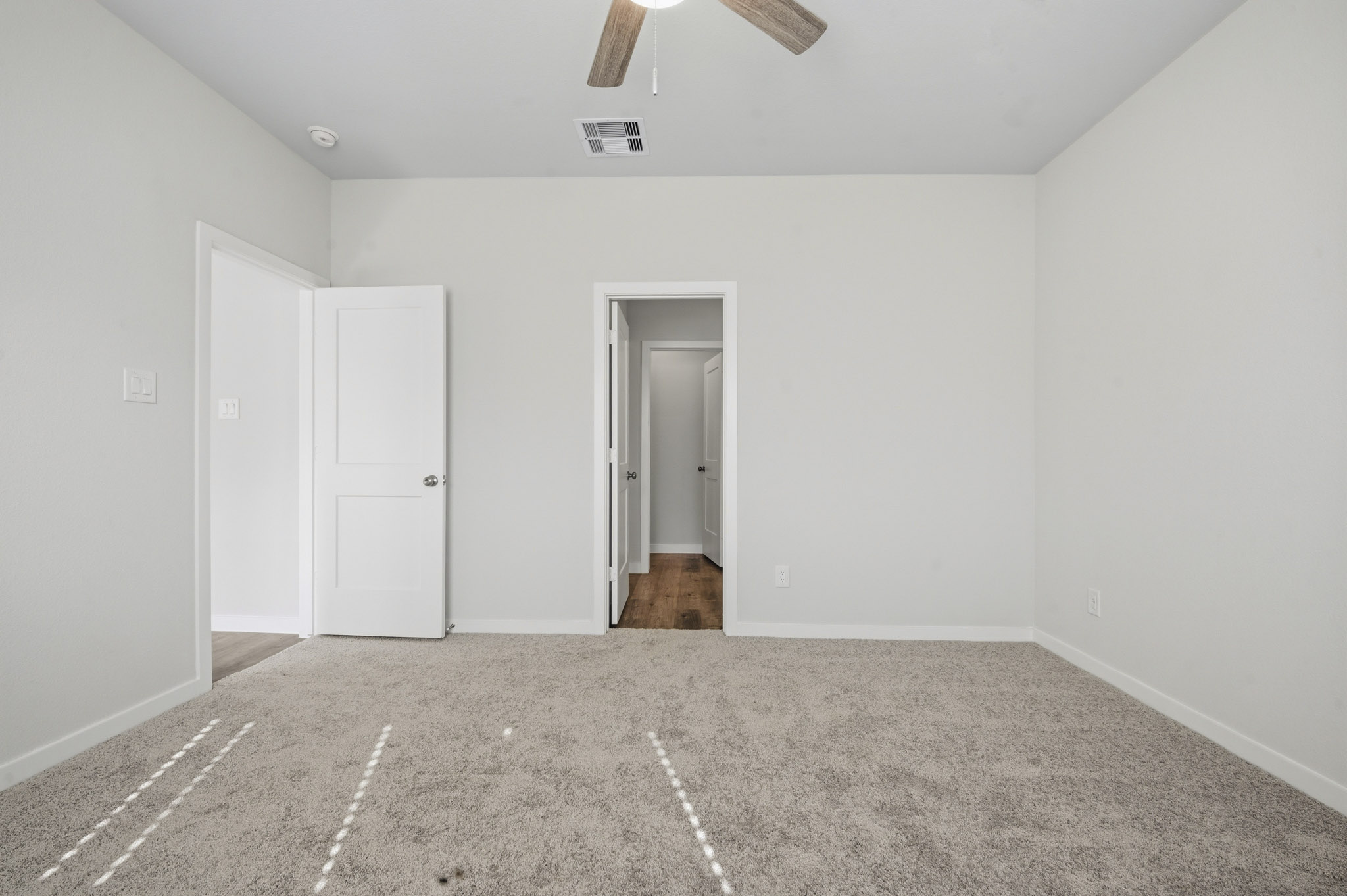 A hallway with white doors.