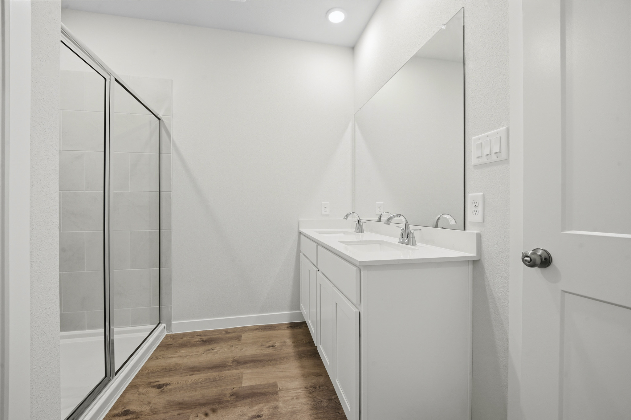 A bathroom with a sink and shower.
