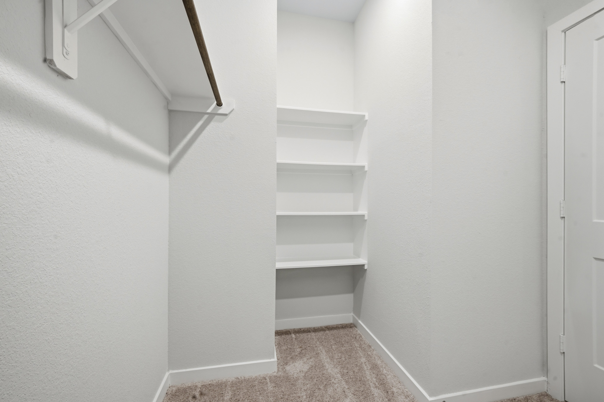 A white room with a white door.