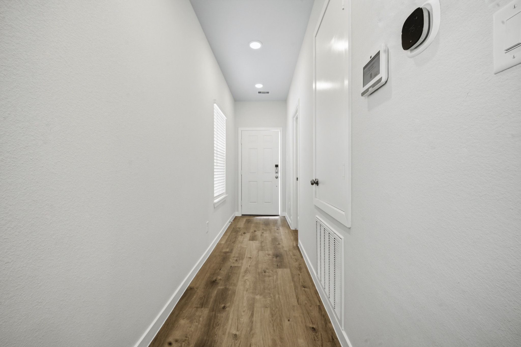 A hallway with white walls.