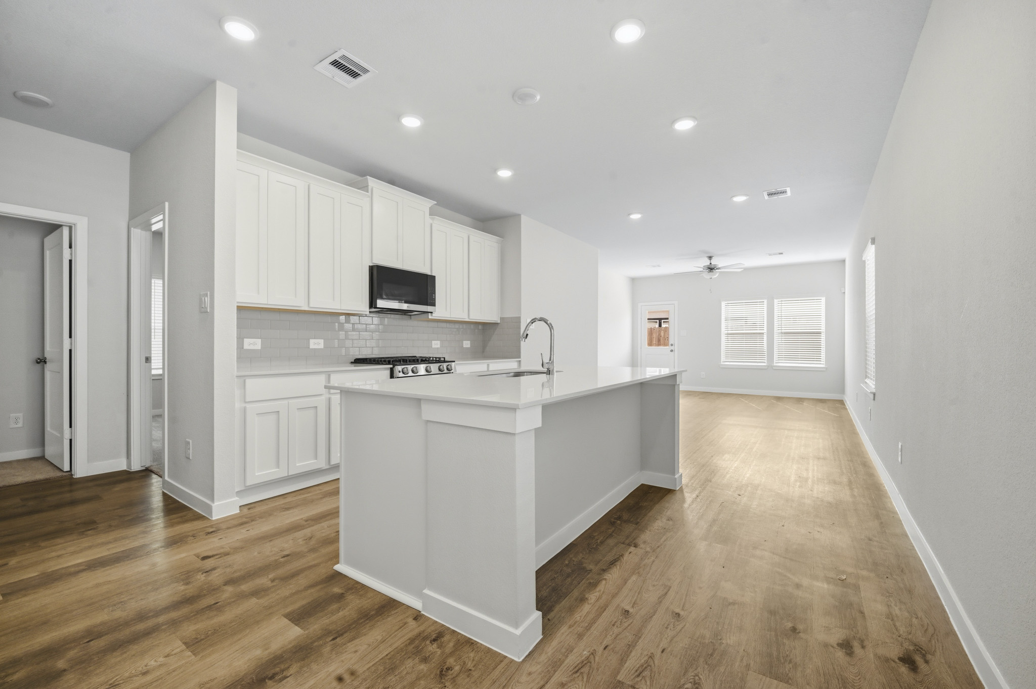 A kitchen with white cabinets.