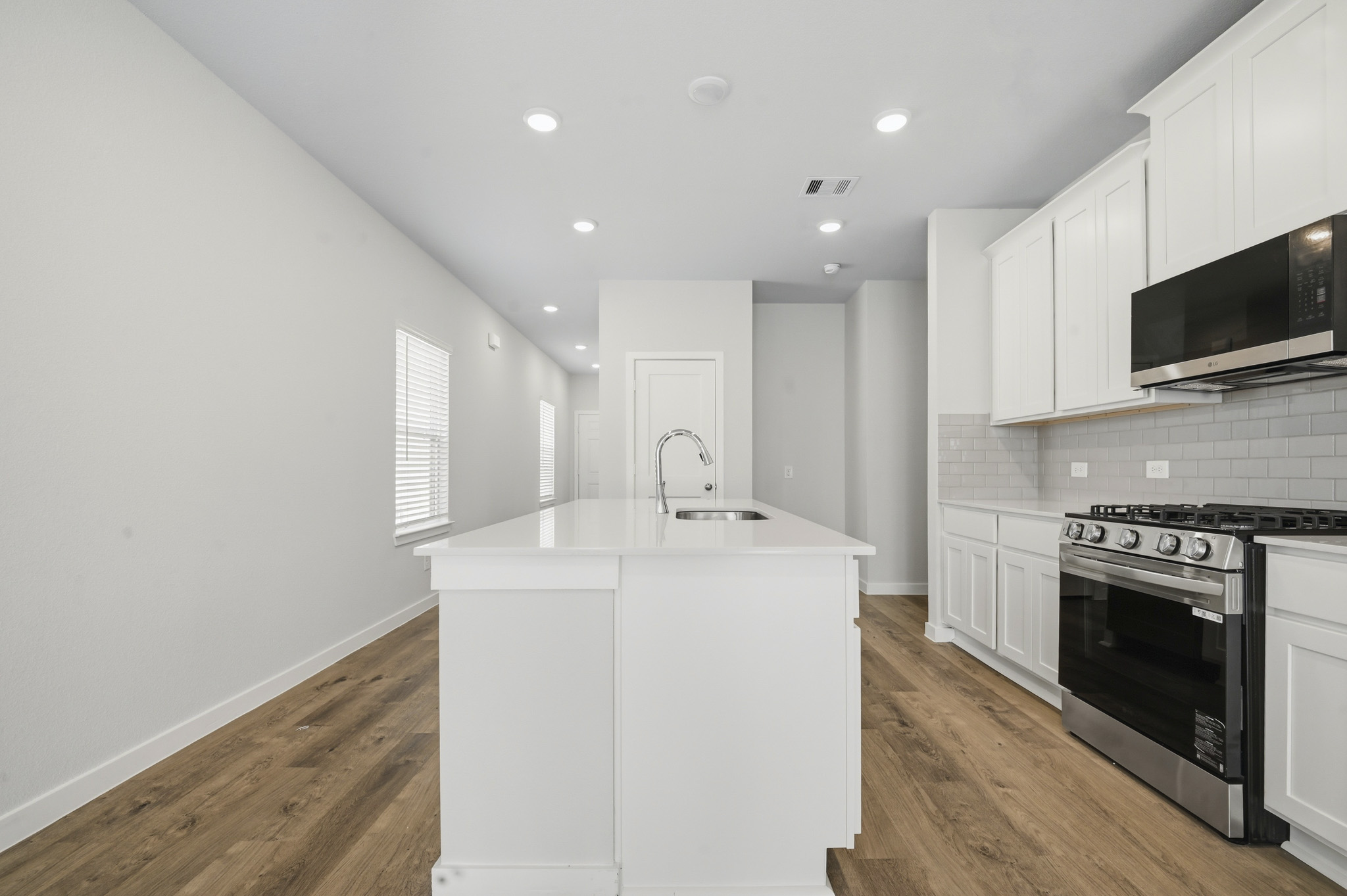 A kitchen with white cabinets.