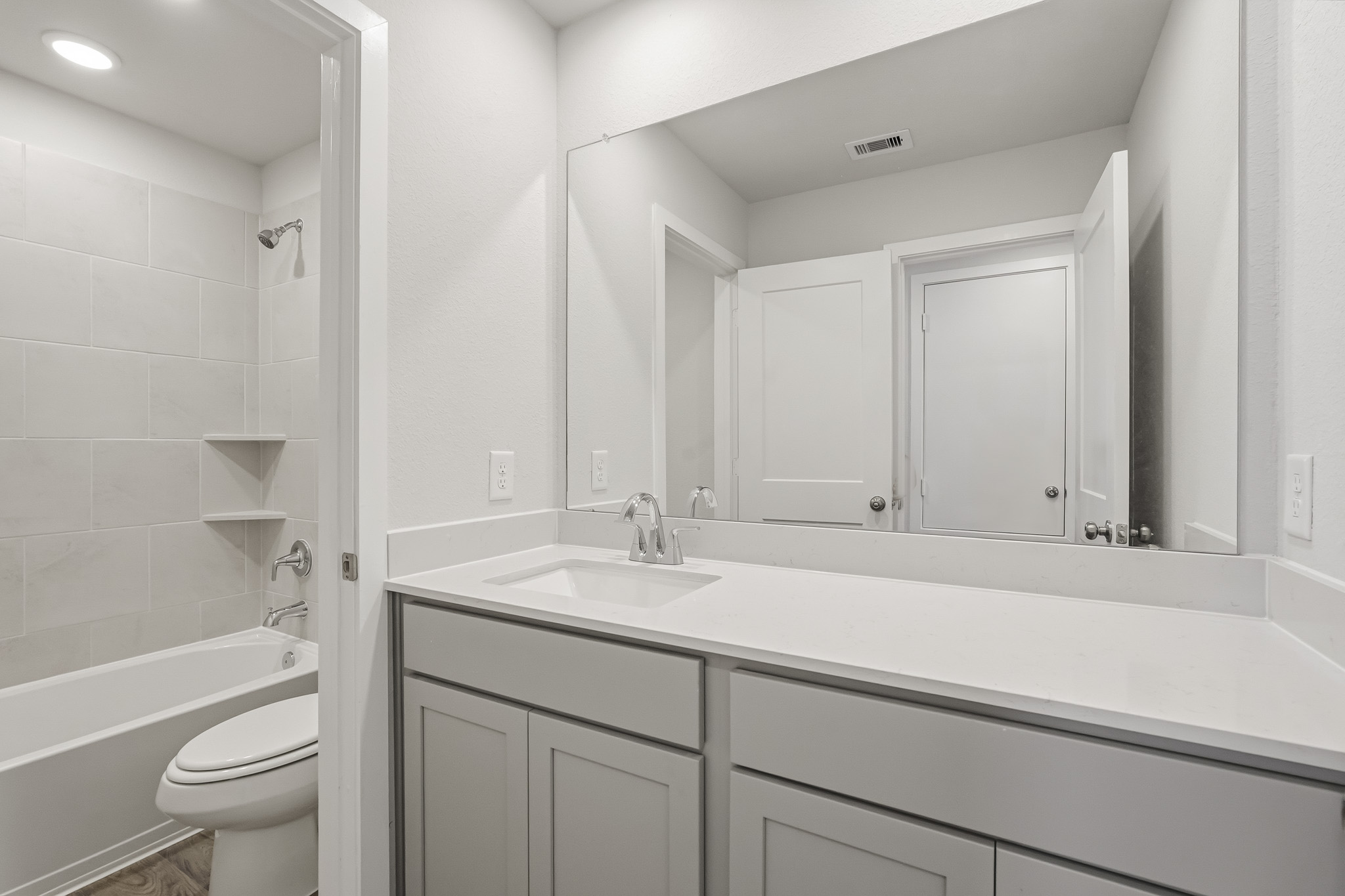A bathroom with a tub sink and toilet.