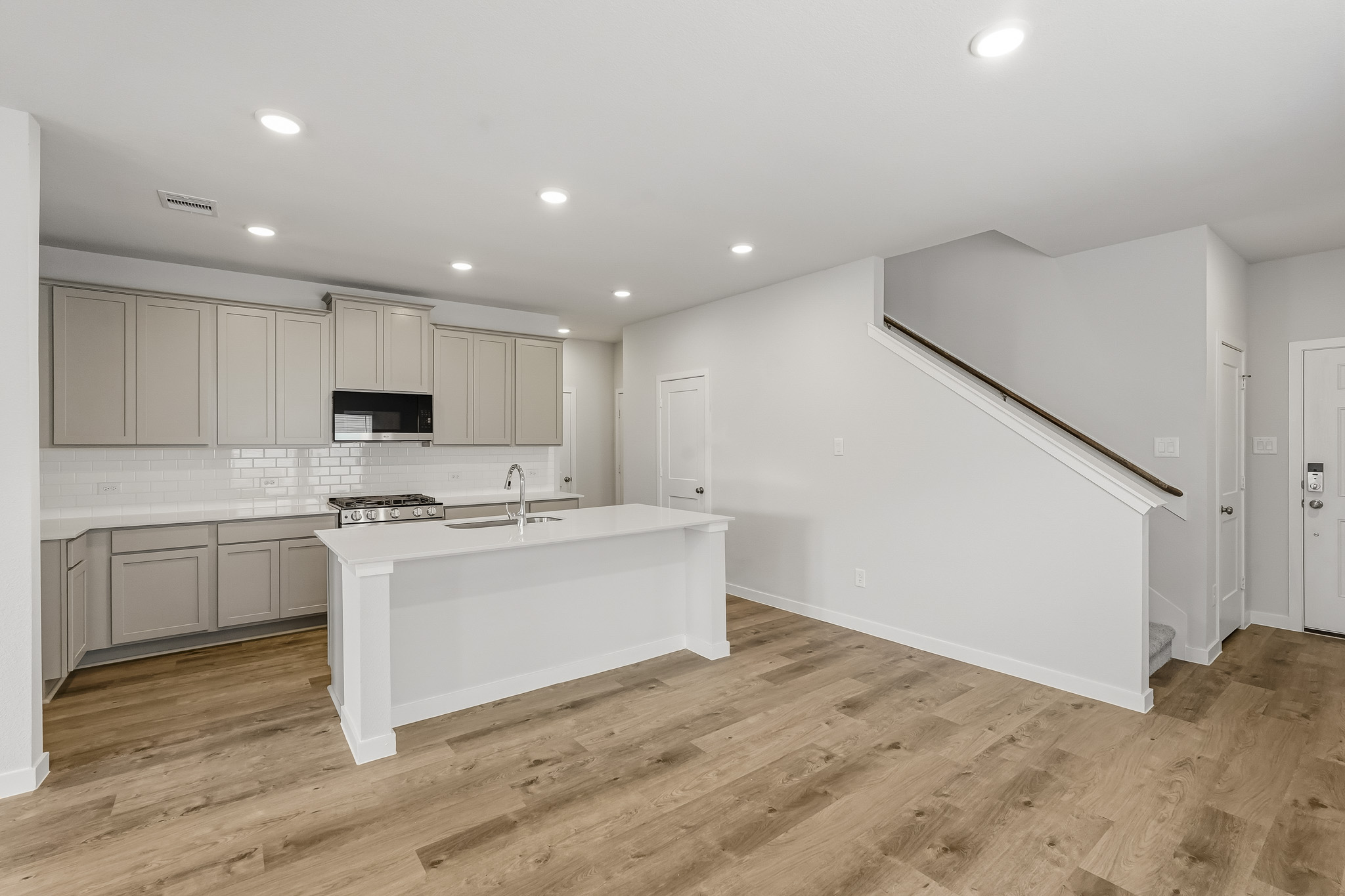 A kitchen with white cabinets.