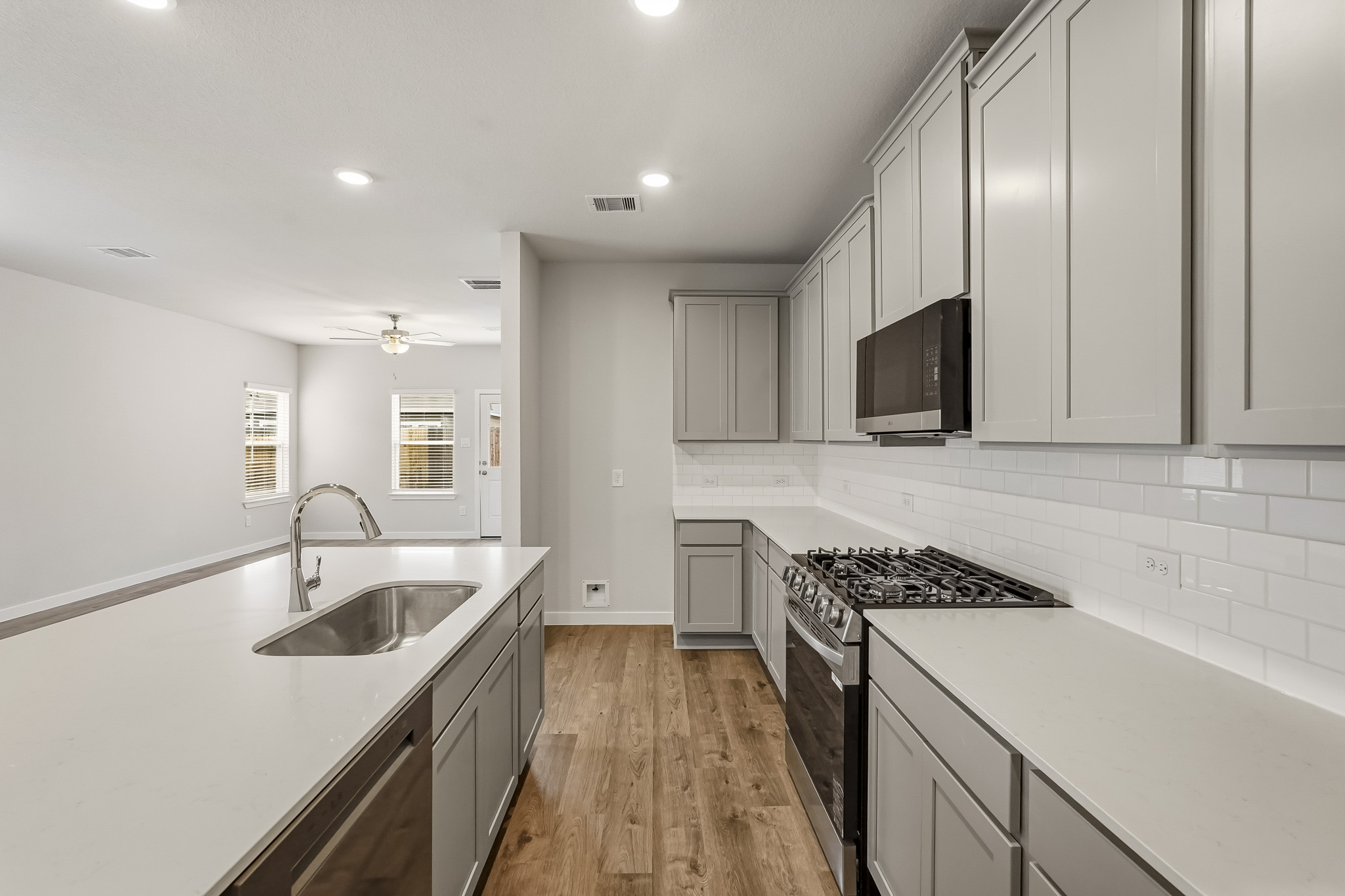 A kitchen with white cabinets.