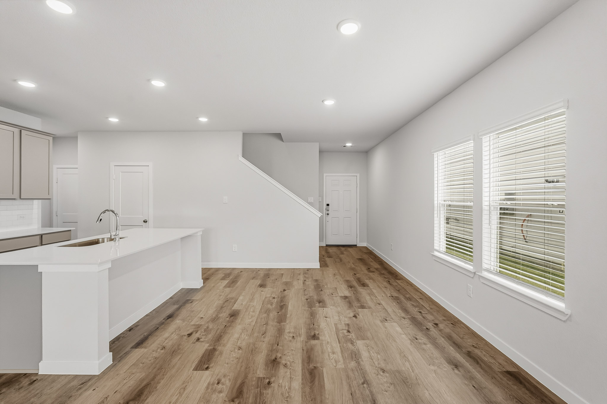 A kitchen with white walls.