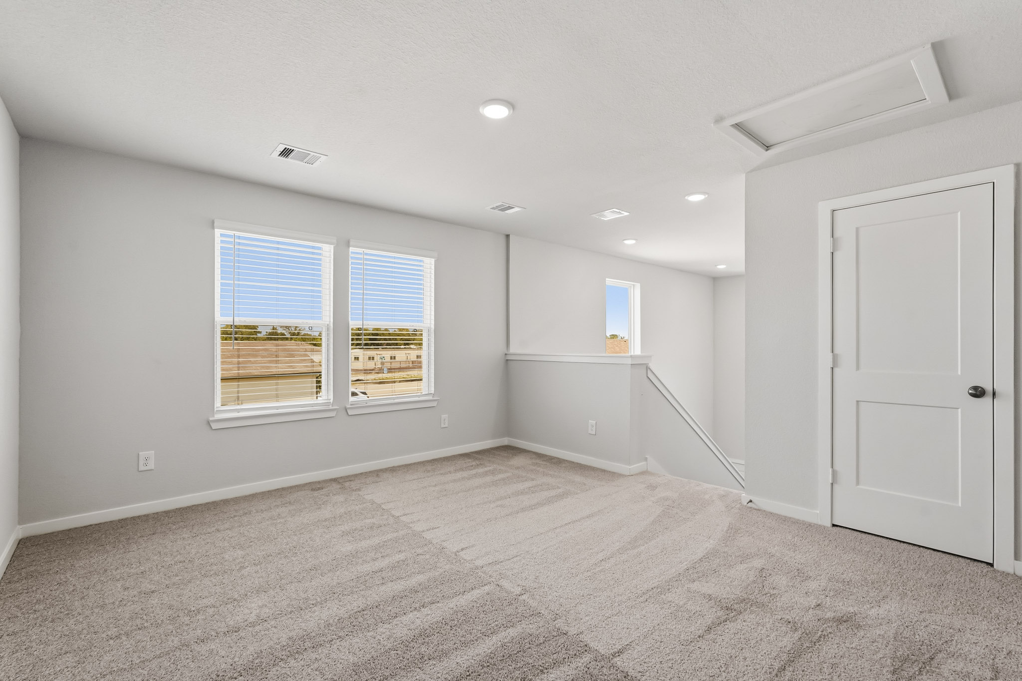 A room with a door and windows.