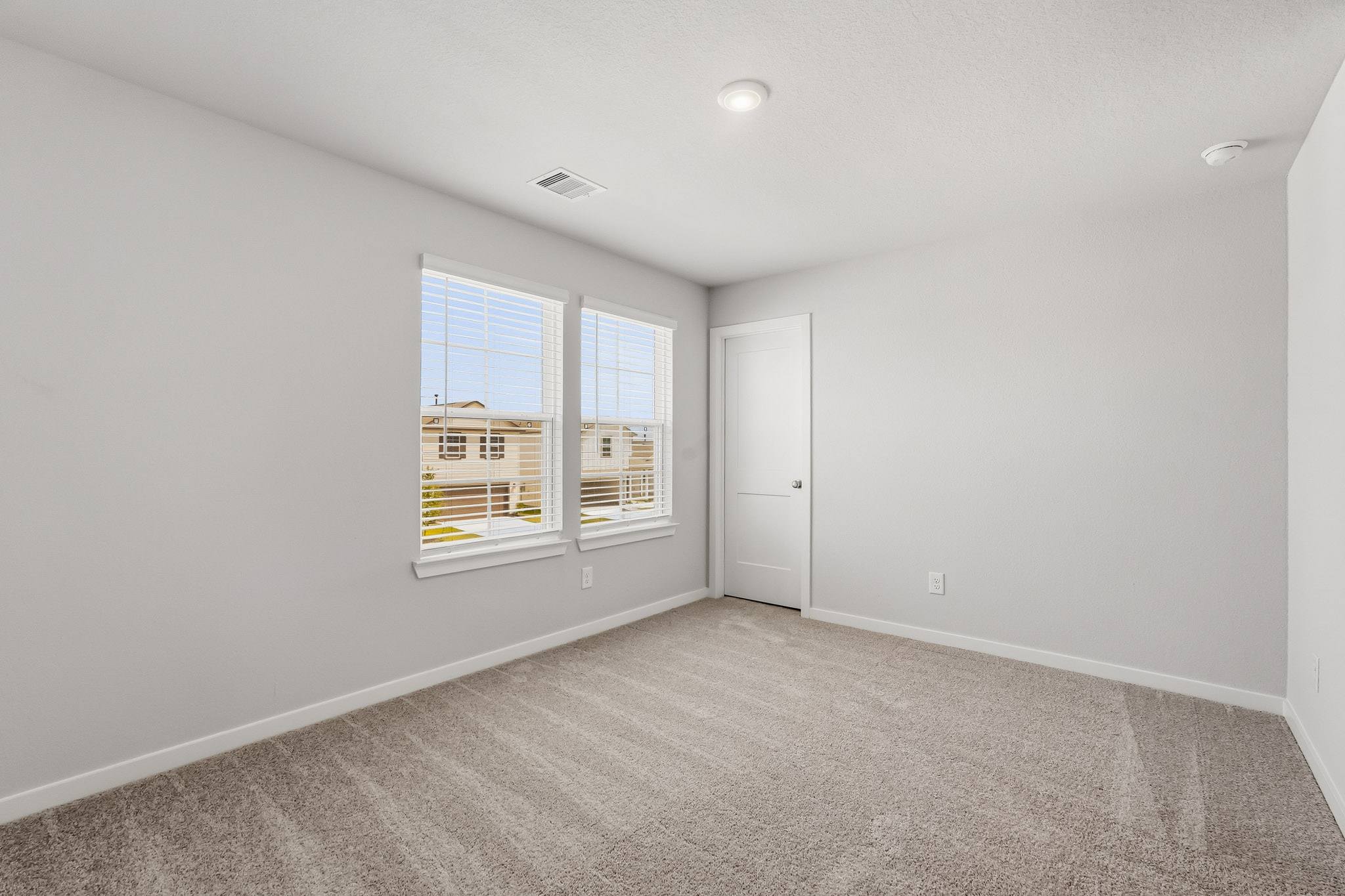 A room with a window and a door.