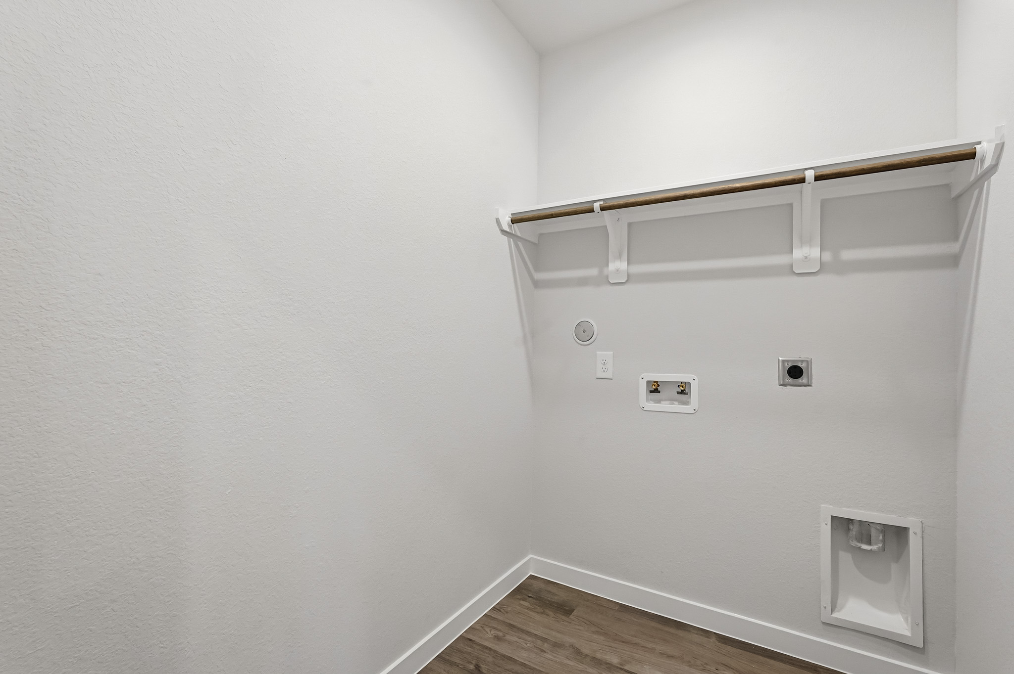 A white wall with a light fixture.