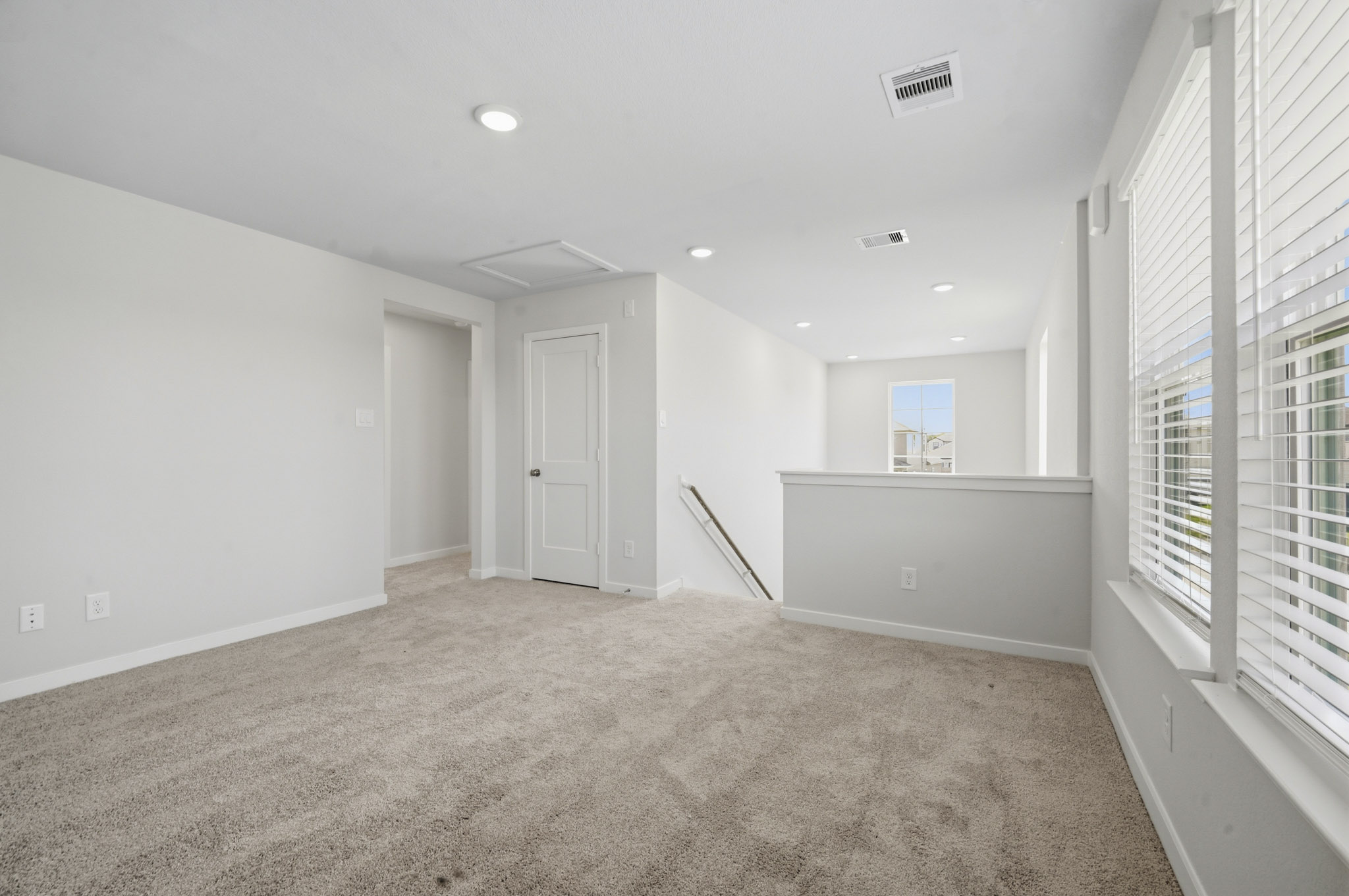 A room with white walls and a carpeted floor.