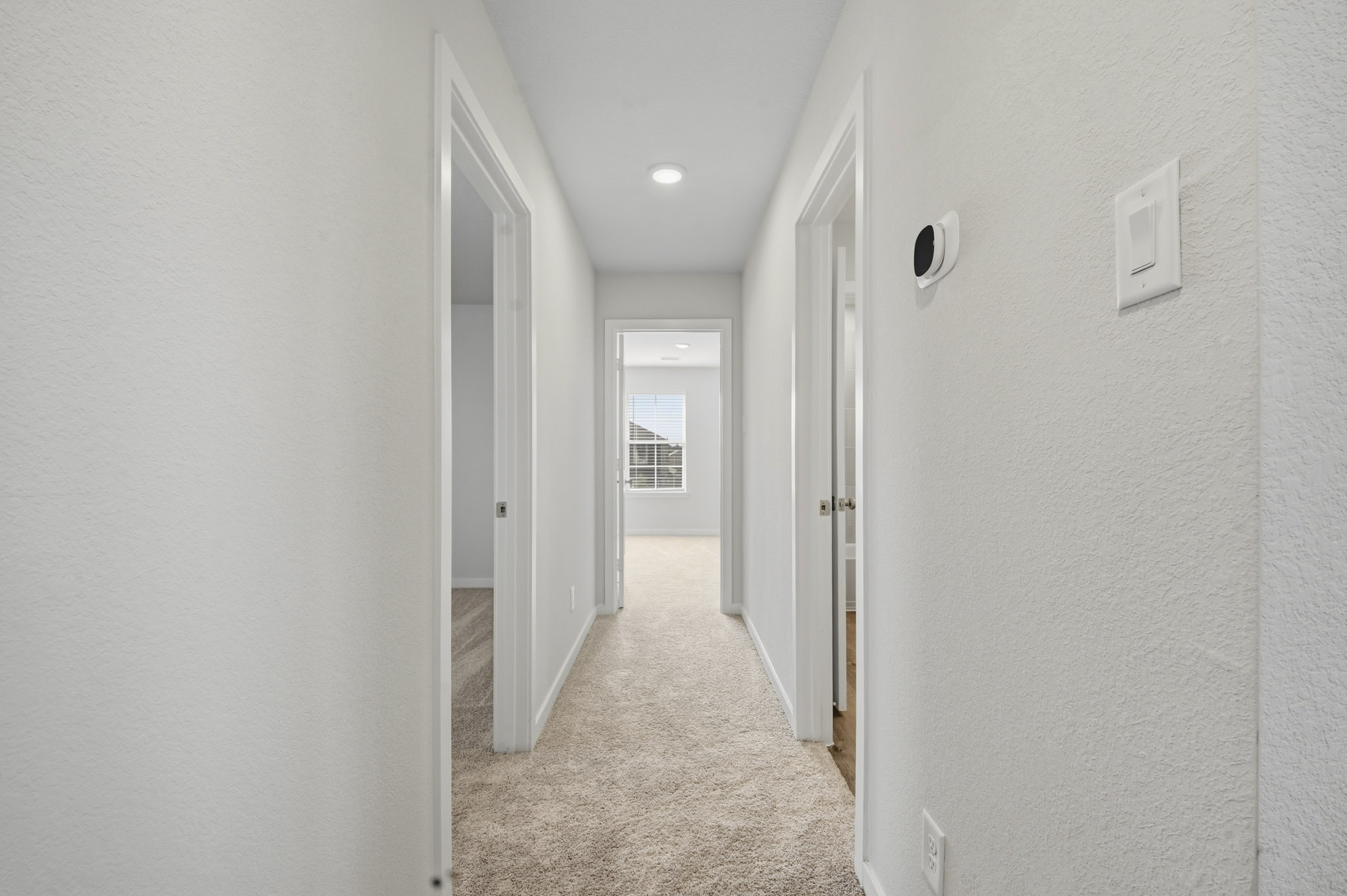 A hallway with white walls.