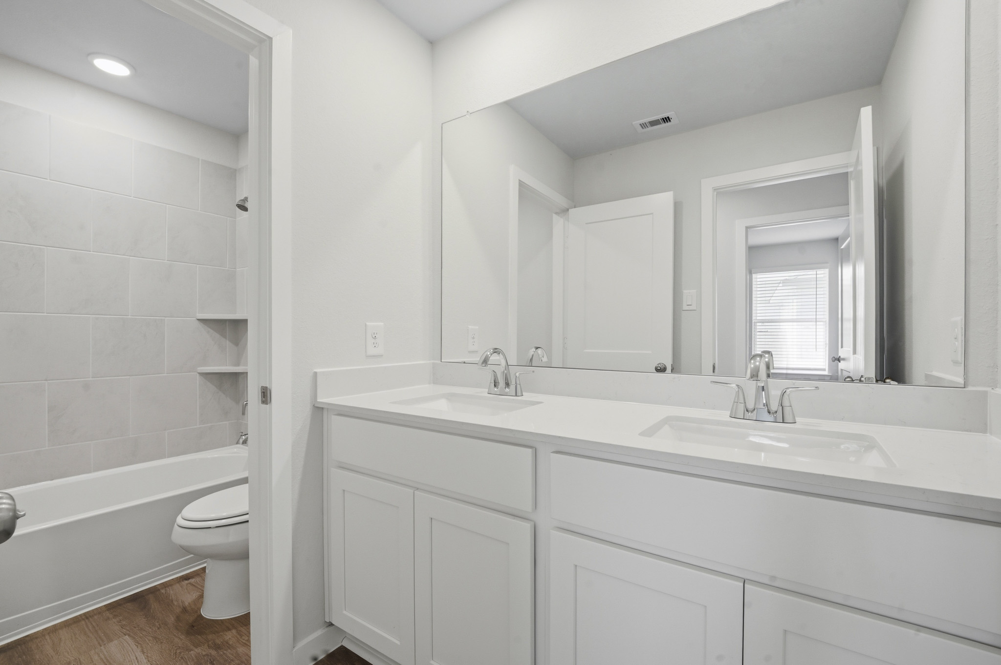 A bathroom with a tub sink and toilet.
