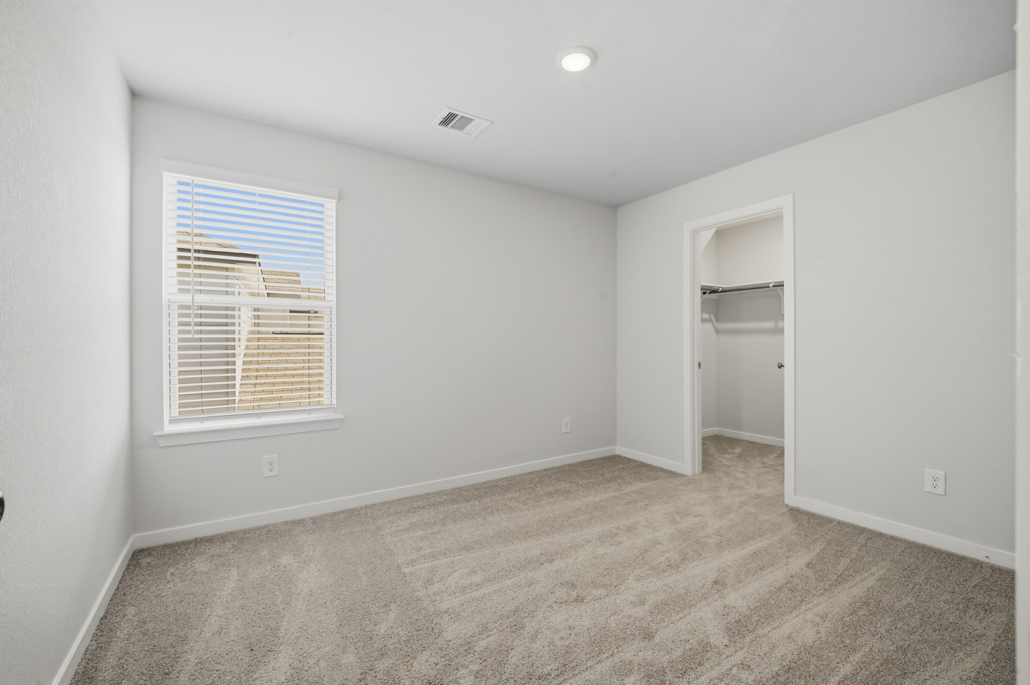 A room with a window and a door.