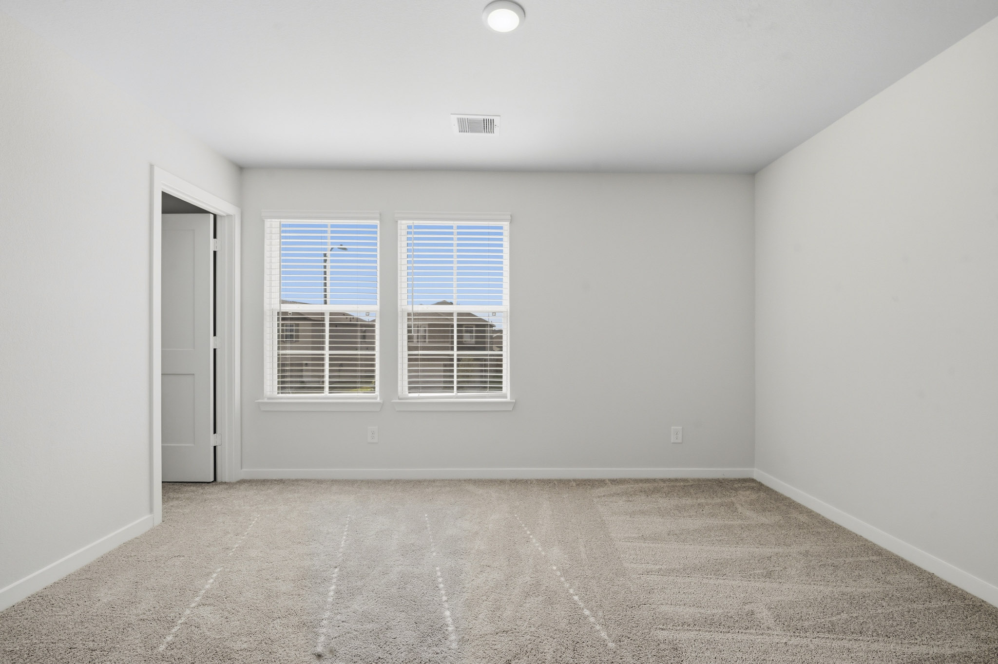 A room with a window and a door.
