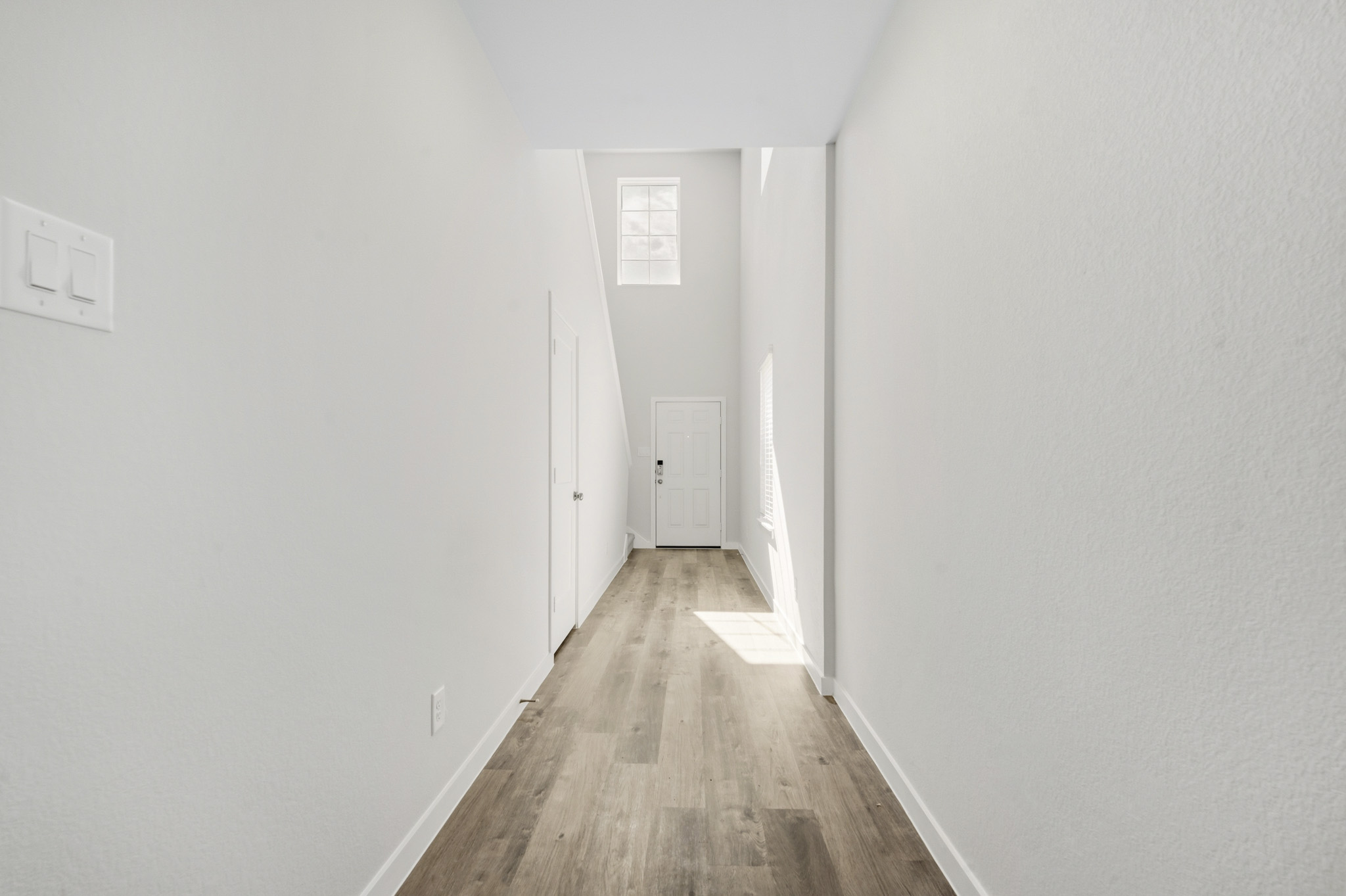 A long hallway with white walls.