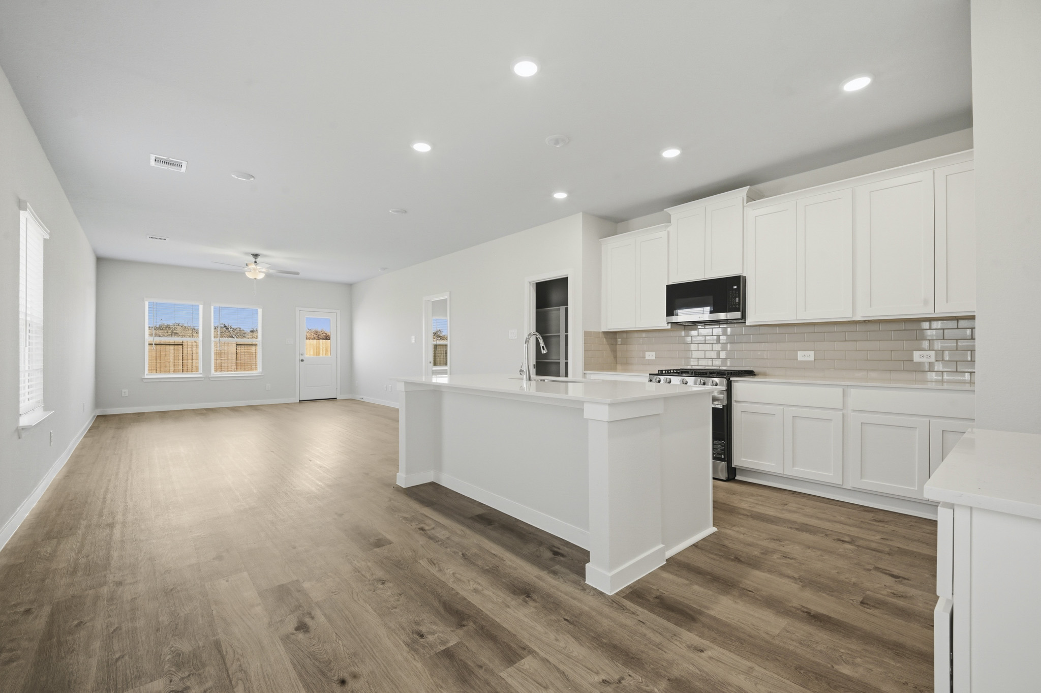 A kitchen with white cabinets.