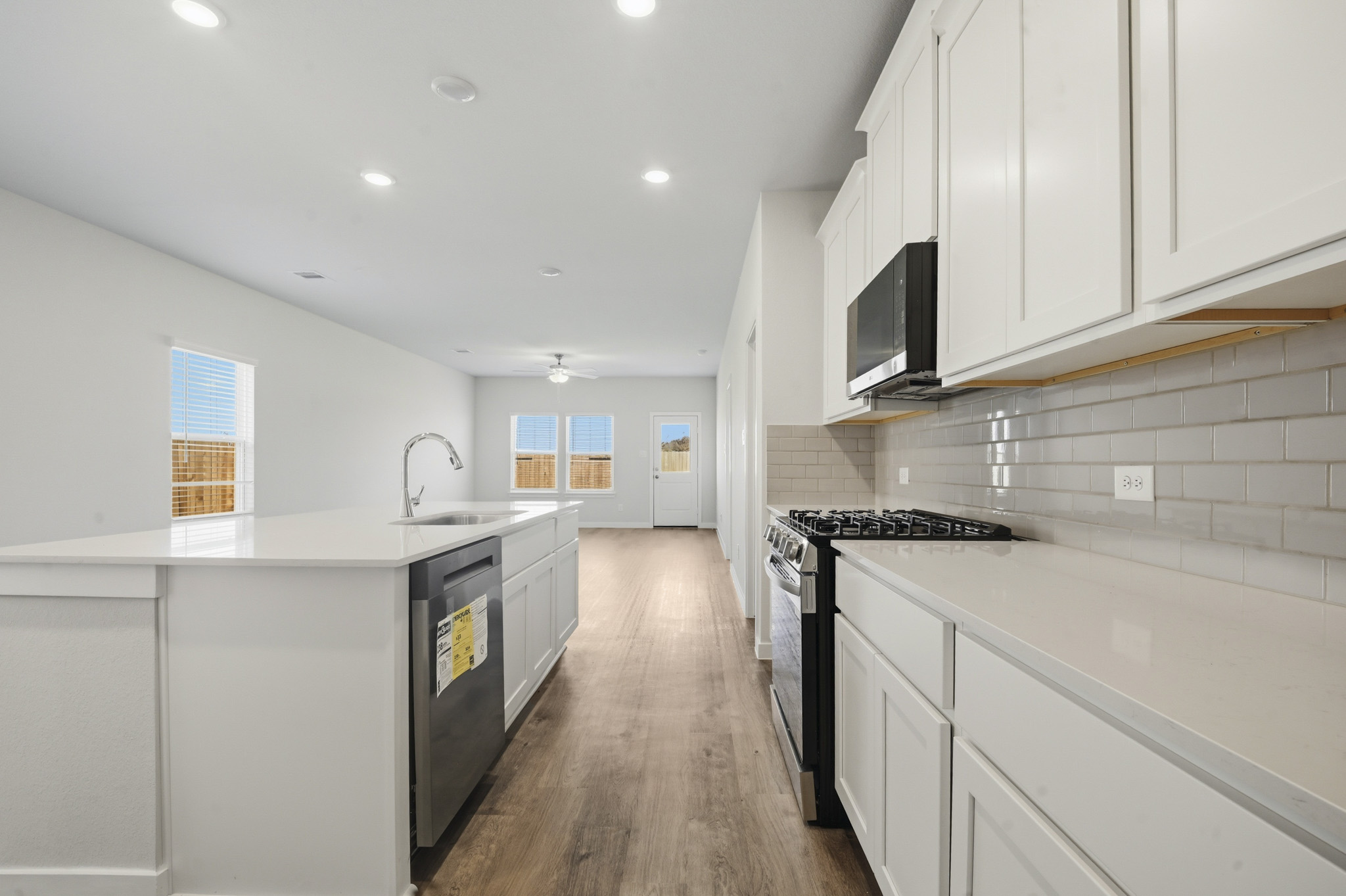 A kitchen with white cabinets.