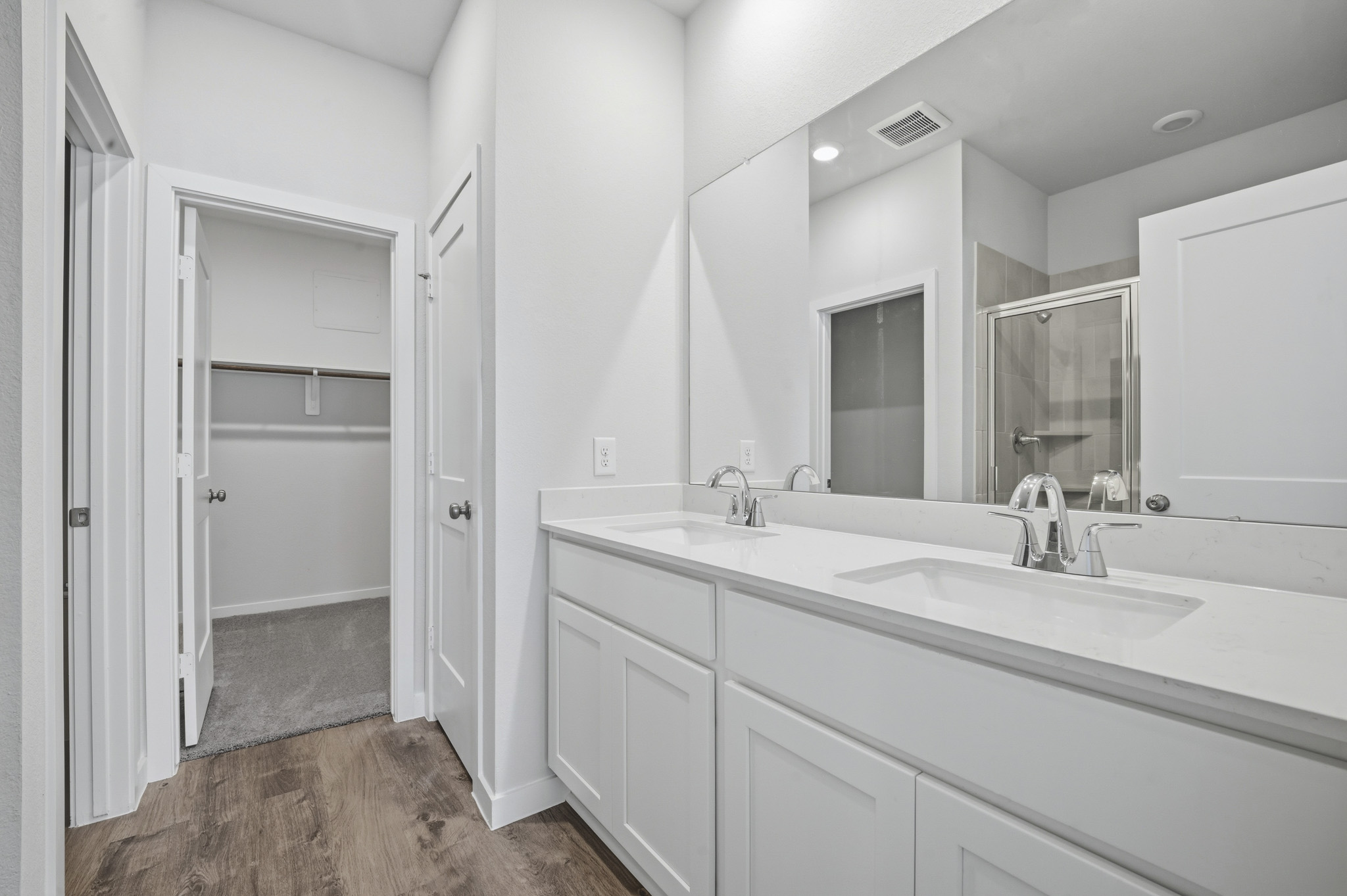 A bathroom with a large mirror.