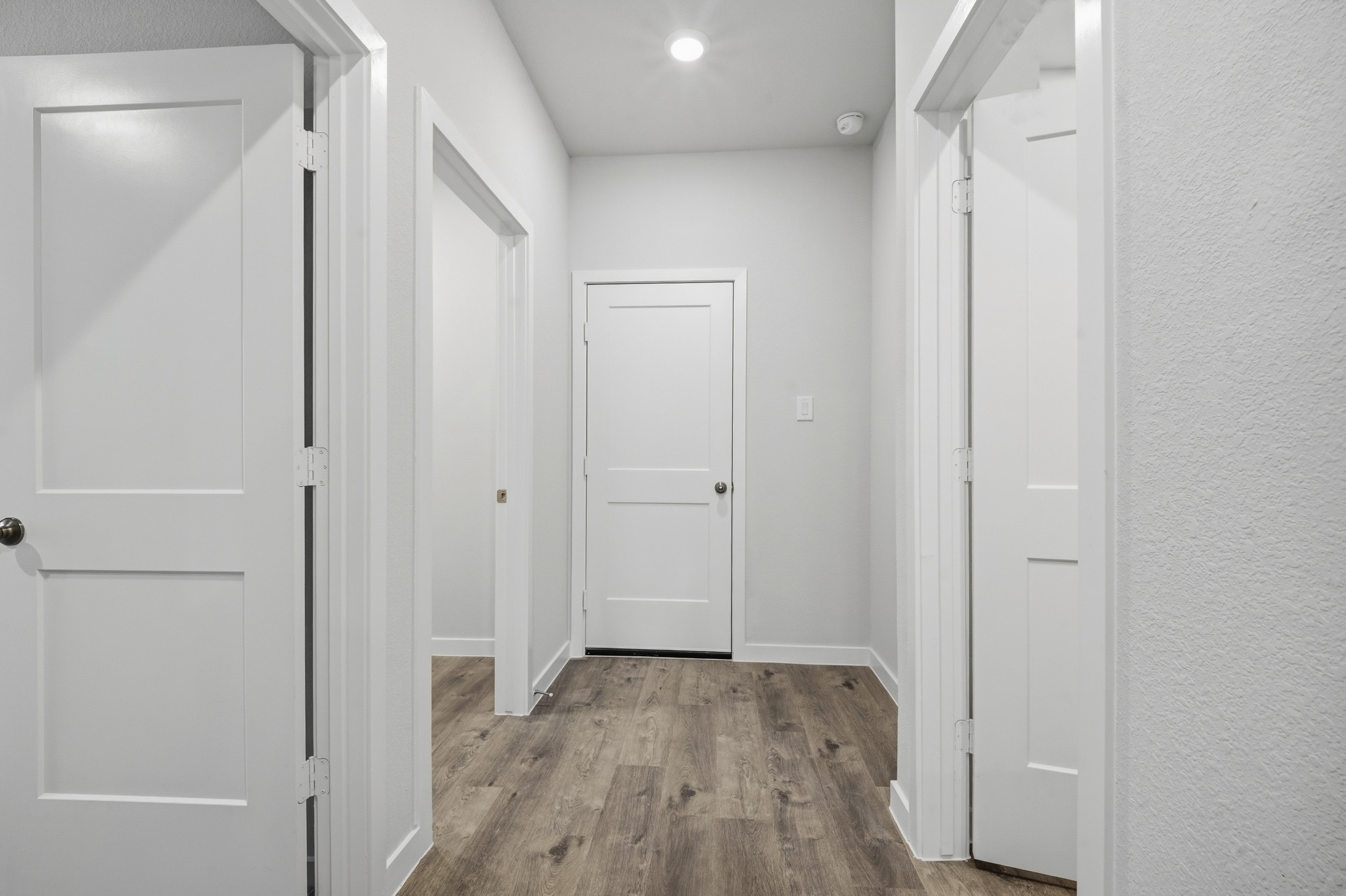 A hallway with white doors.