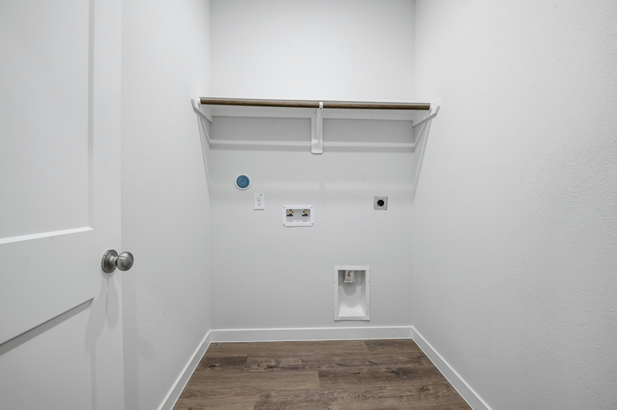 A white wall with a light fixture.