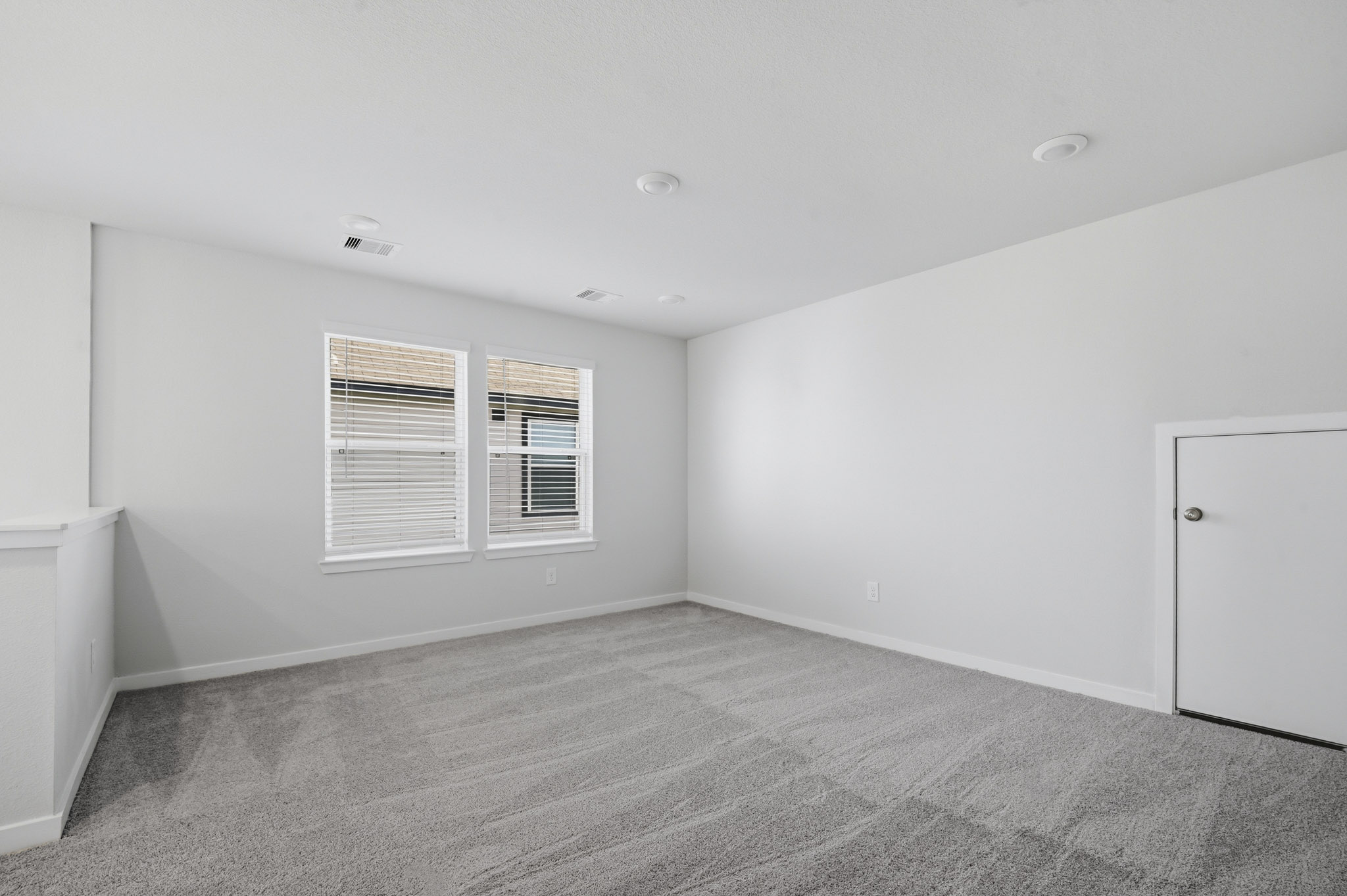 A room with a door and windows.