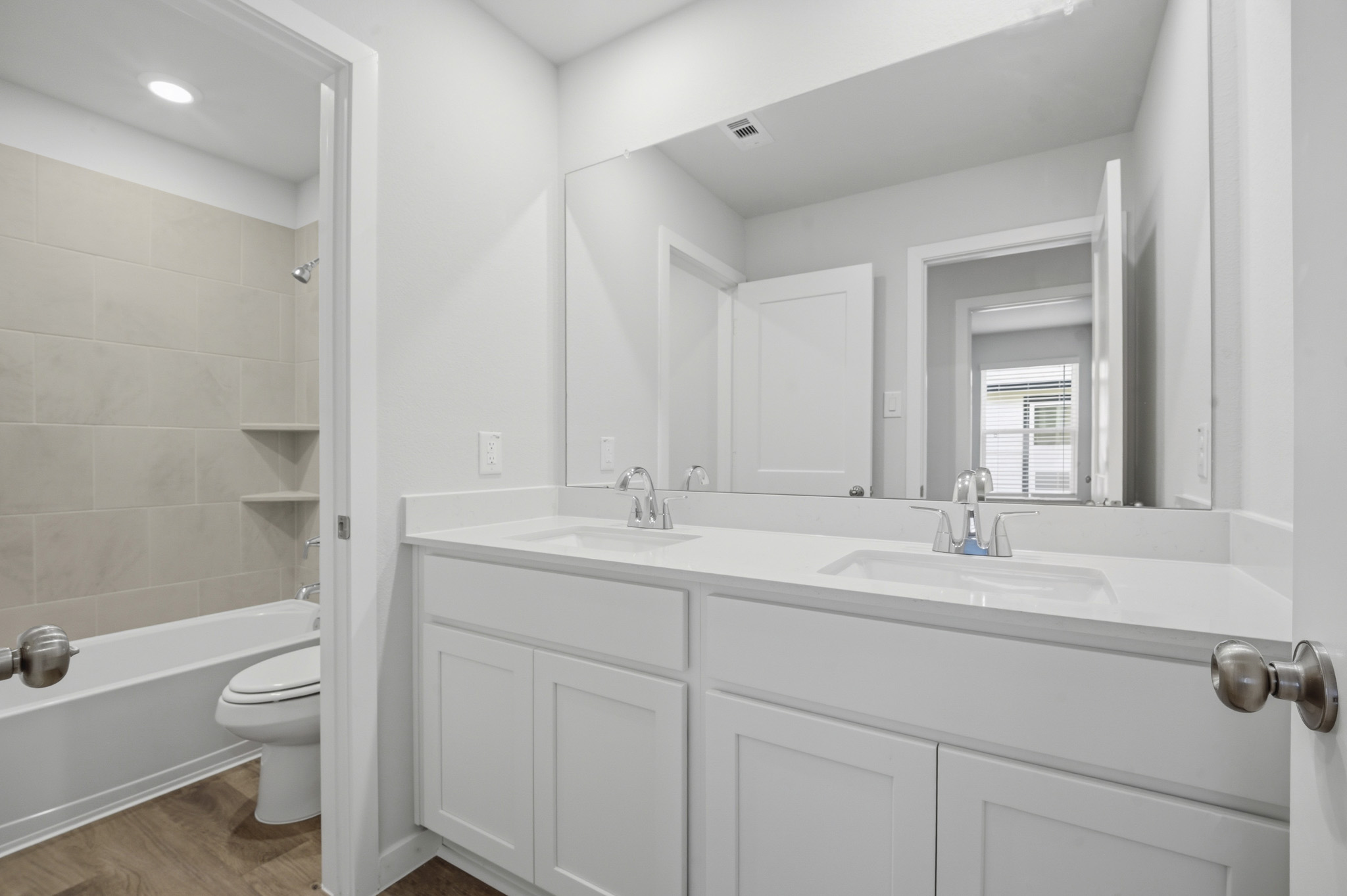 A bathroom with a tub sink and toilet.