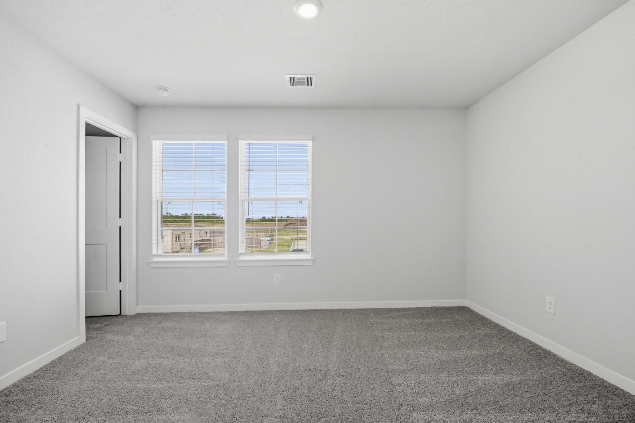 A room with a window and a door.