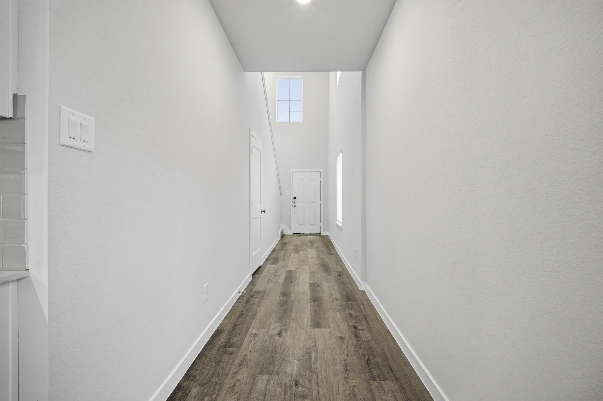 A hallway with white walls.