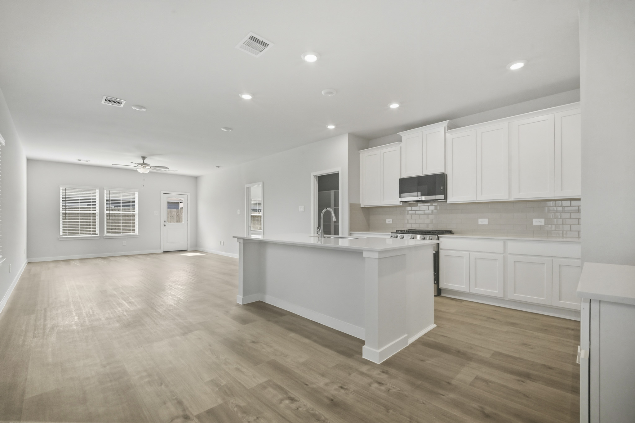 A kitchen with white cabinets.