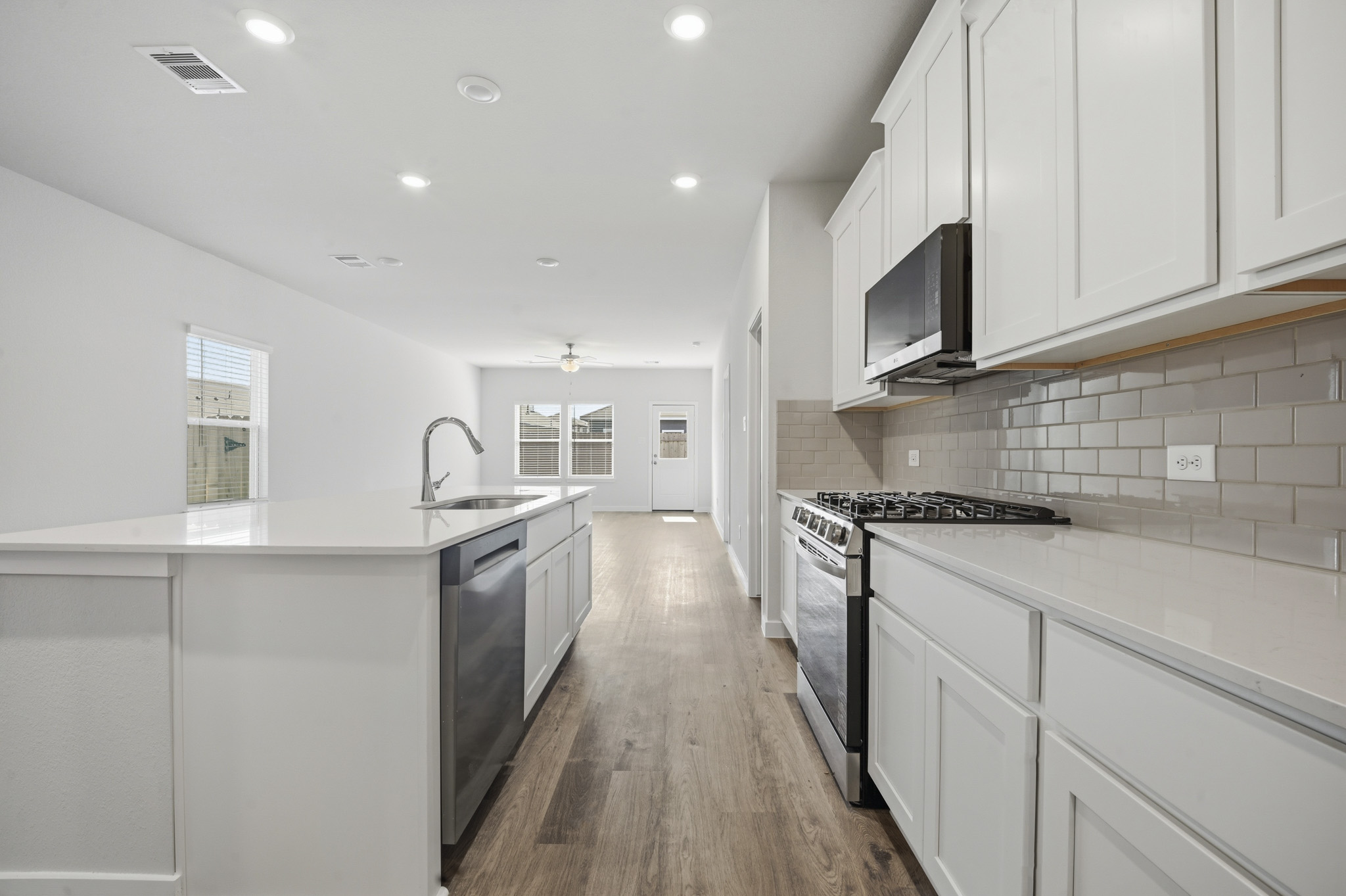 A kitchen with white cabinets.