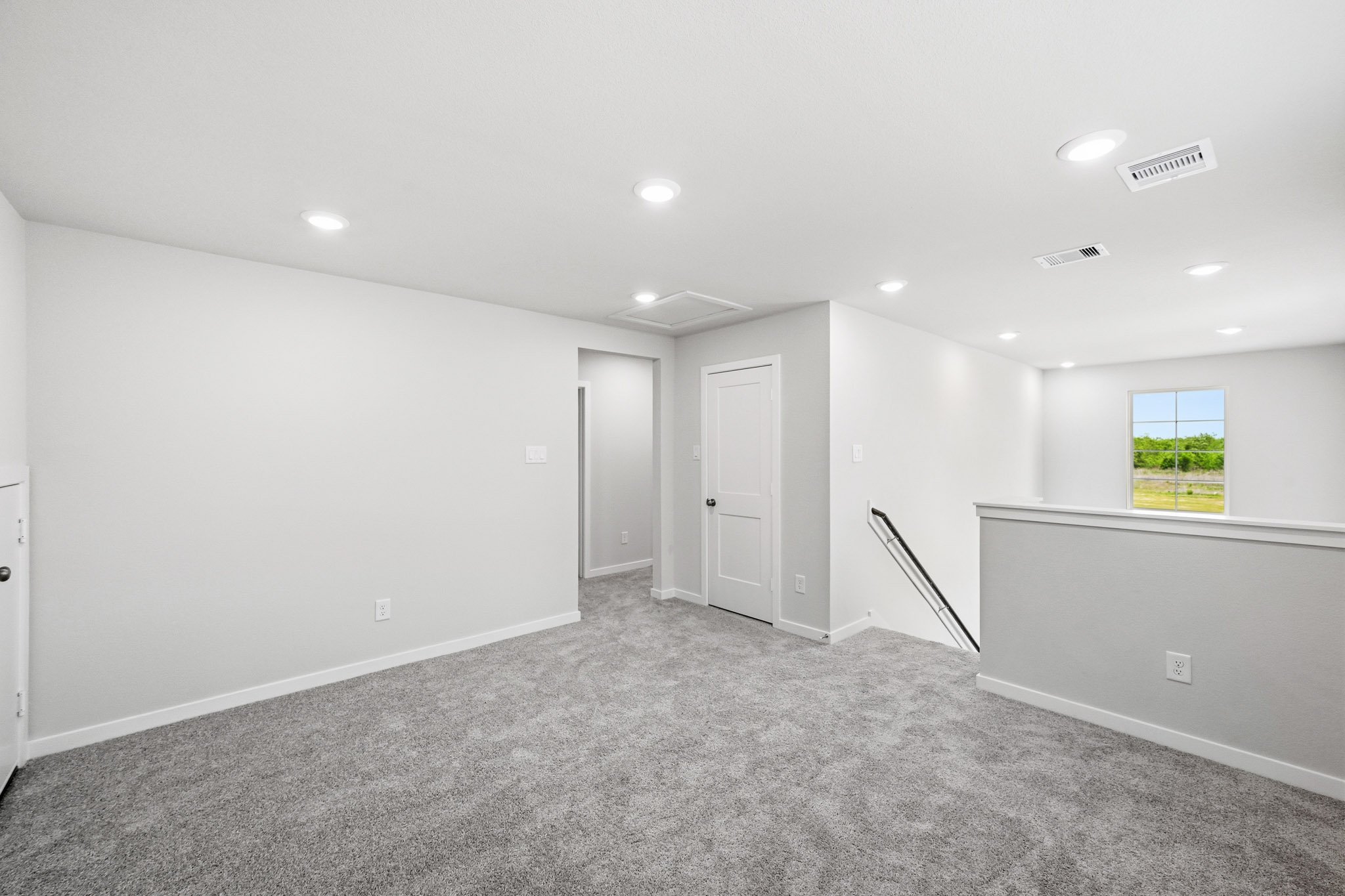 A room with white walls and a window.